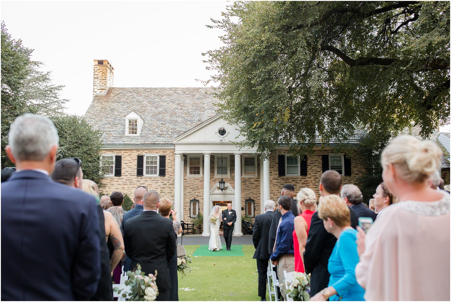 bride and father walk down the aisle at Huntingdon Valley Country Club wedding day photographed by Idalia Photography