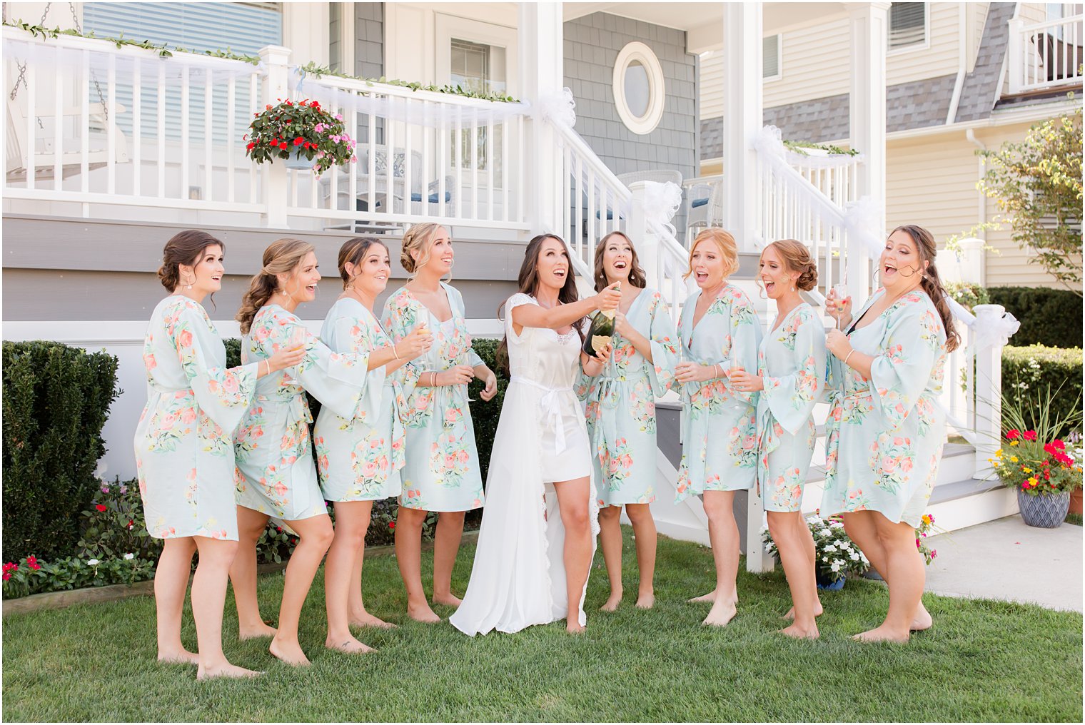 Bridesmaids opening champagne with bride on wedding day