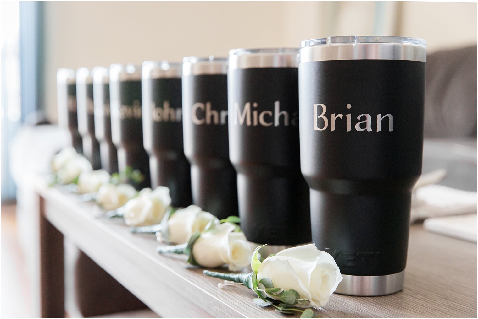 groomsmen gifts and ivory rose boutonnières 