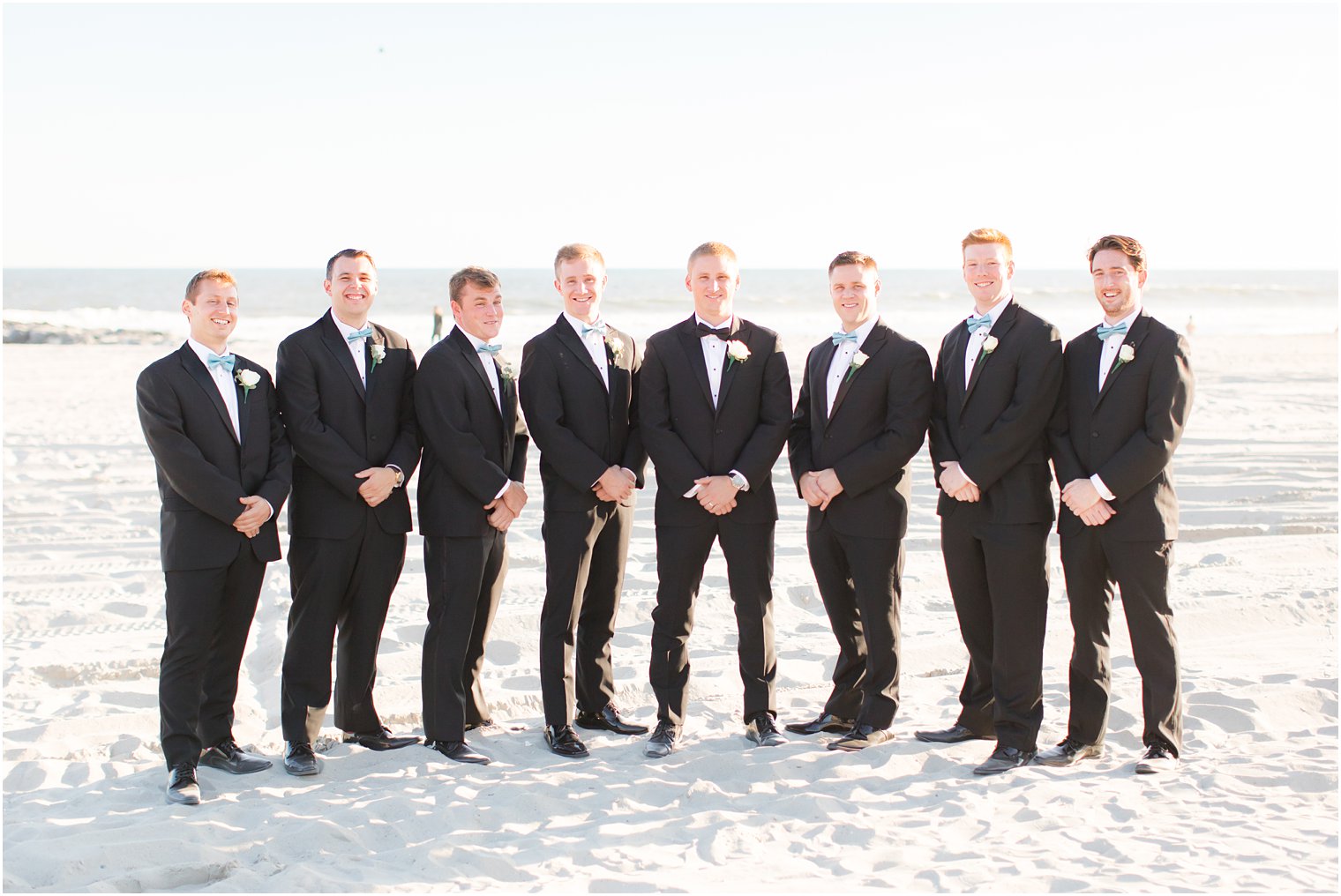 groomsmen on beach during Bridgeview Yacht Club wedding