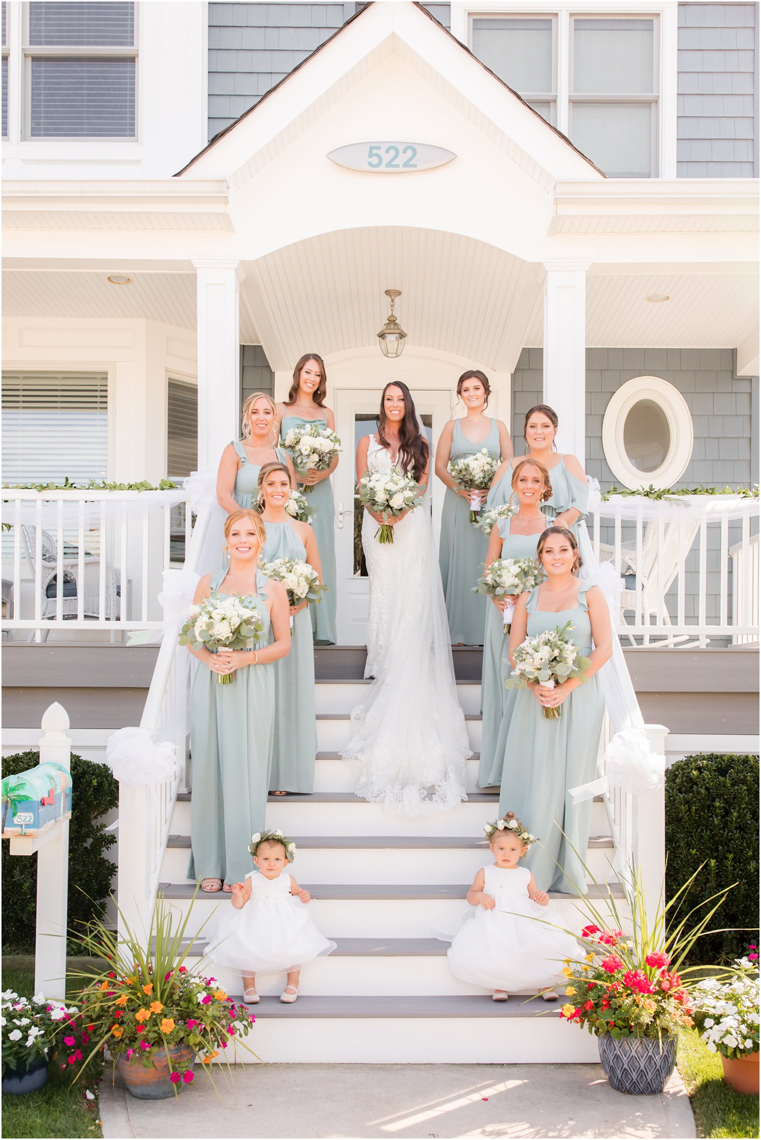 bride and bridesmaids in sage green gowns at LBI beach house