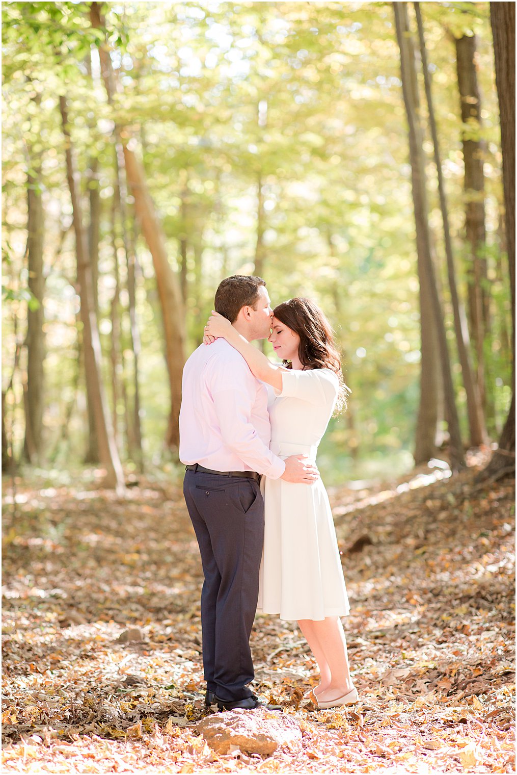 groom kisses bride's forehead during NJ engagement photos