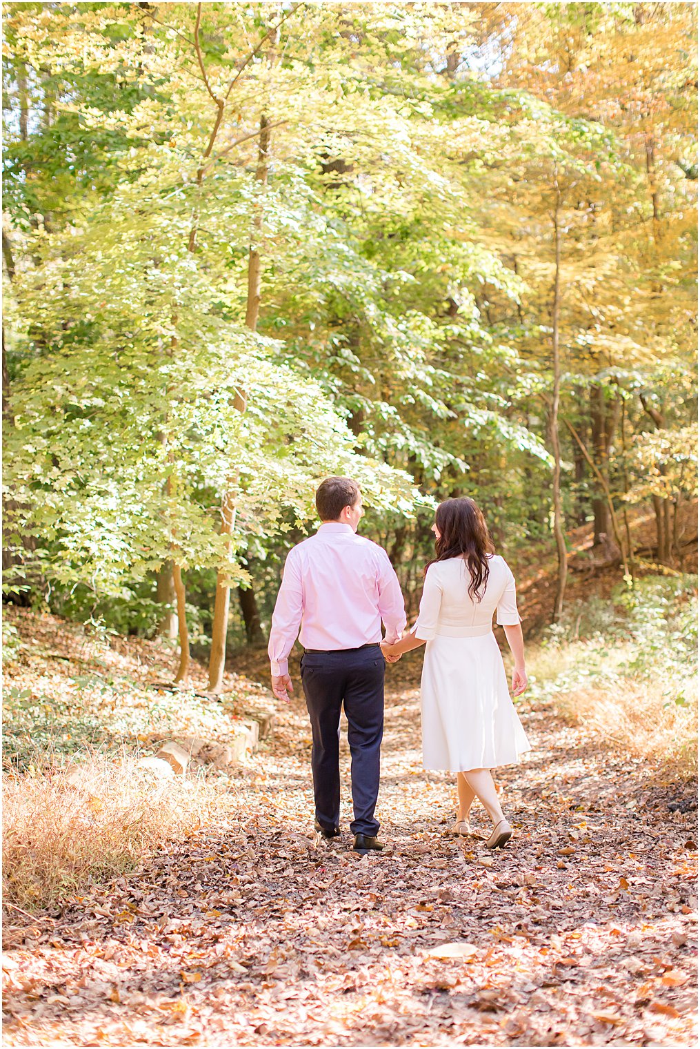 couple walks through Watchung Reservation during engagement photos