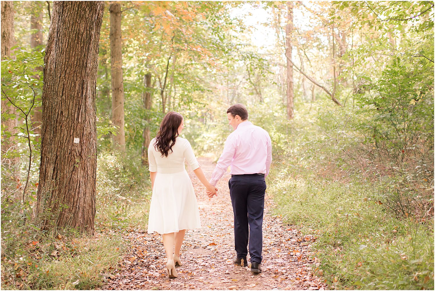 engaged couple walks through woods of Watchung Reservation