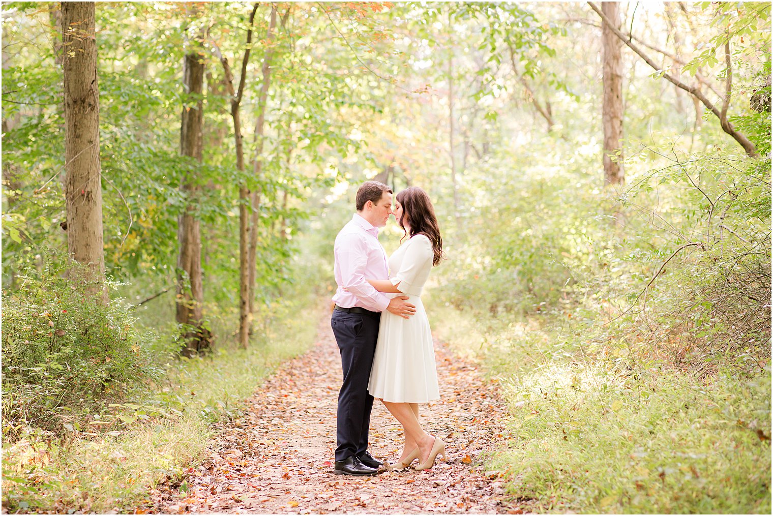 bride and groom stand nose to nose on path in Watchung Reservation