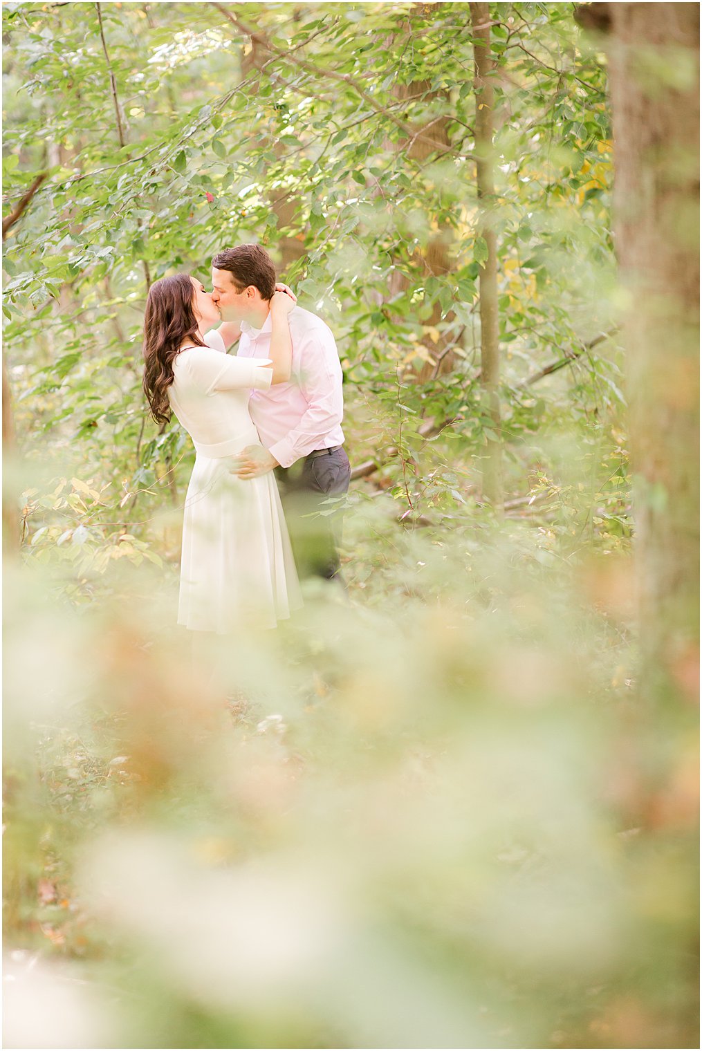 couple kisses in woods in Union County NJ during engagement photos