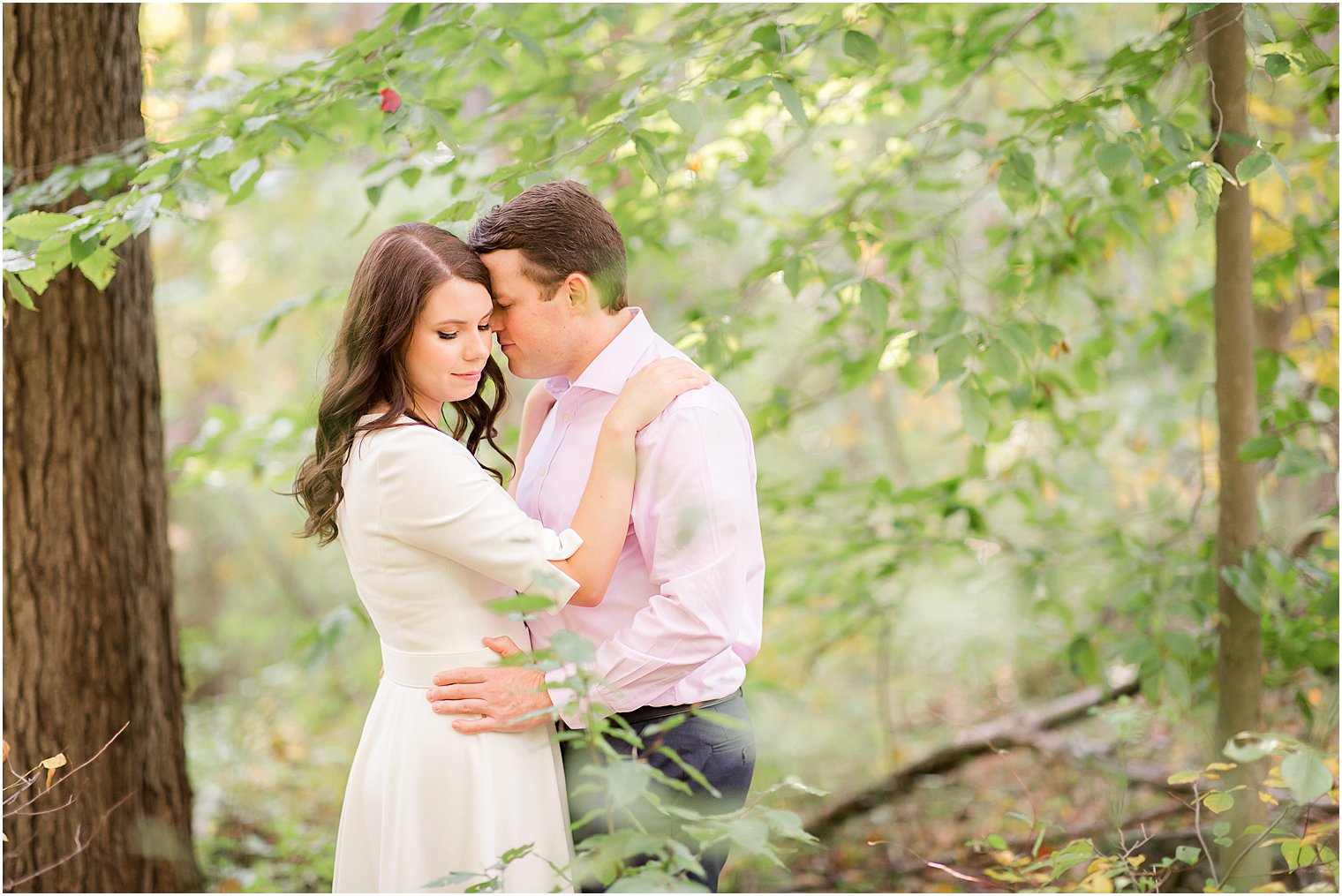 groom nuzzles bride's cheek during fall New Jersey engagement session