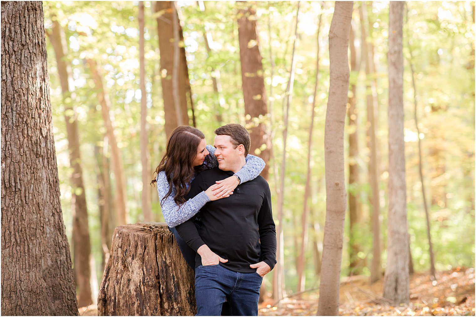 bride and groom lean against stump in Union County NJ