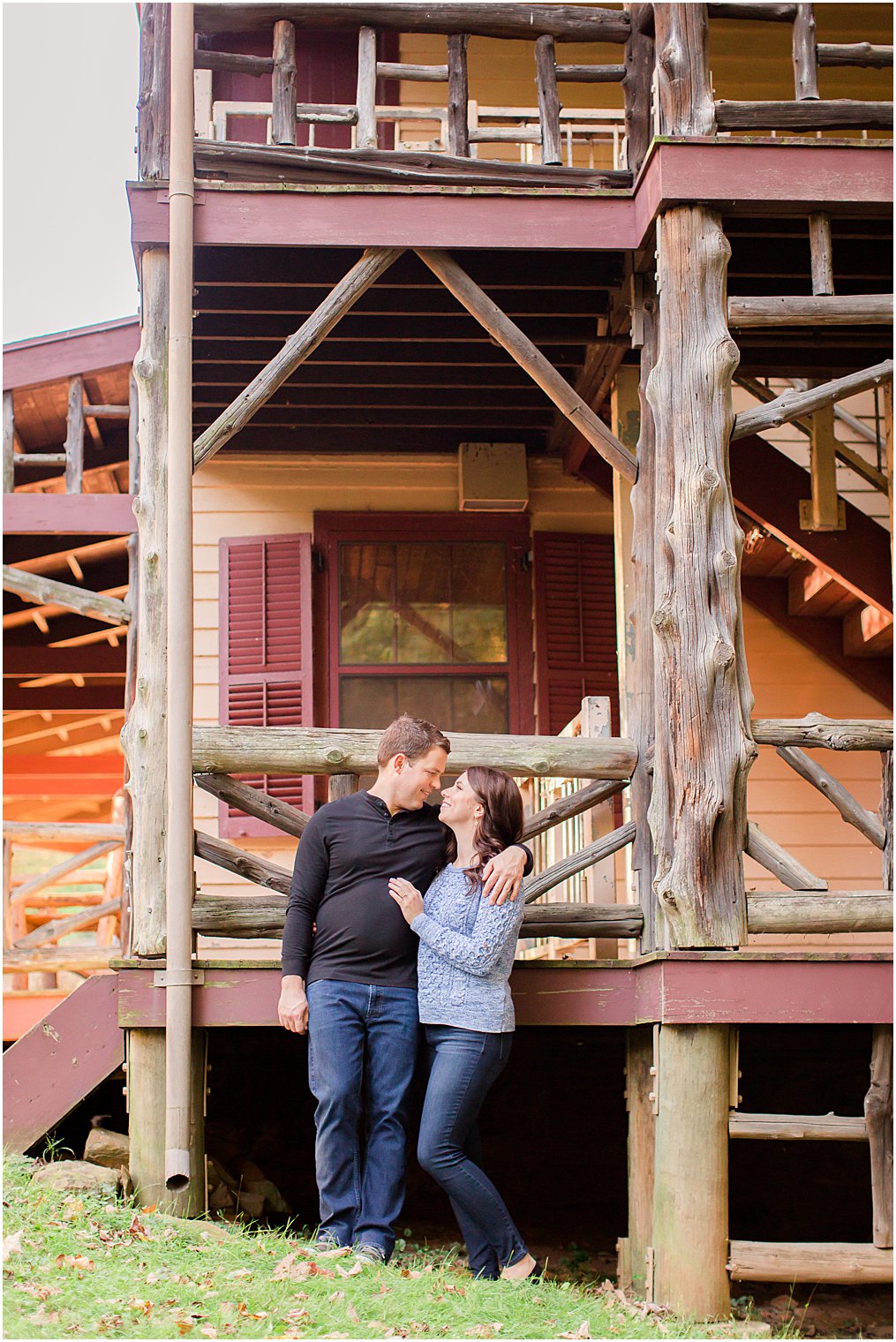 engaged couple stands by lodge at Watchung Reservation