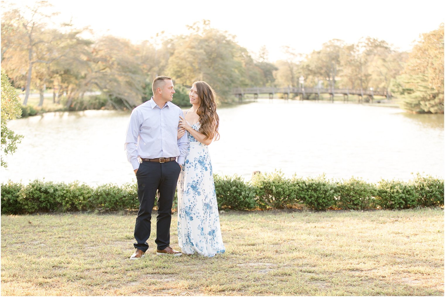 engaged couple poses by lake in New Jersey