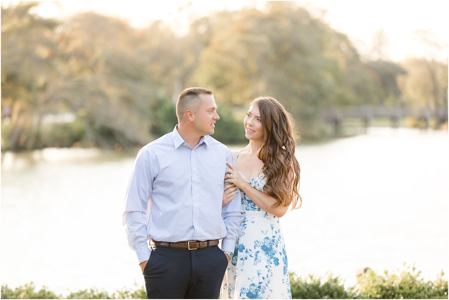 bride holds groom's arm during Spring Lake Engagement session