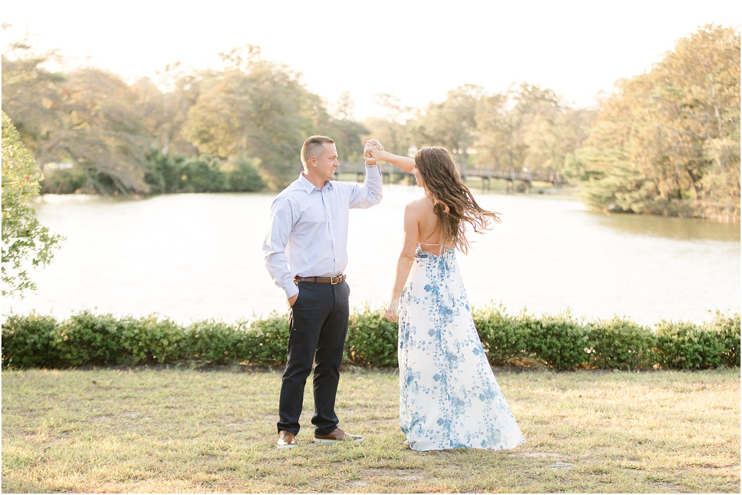 groom twirls bride during NJ engagement photos