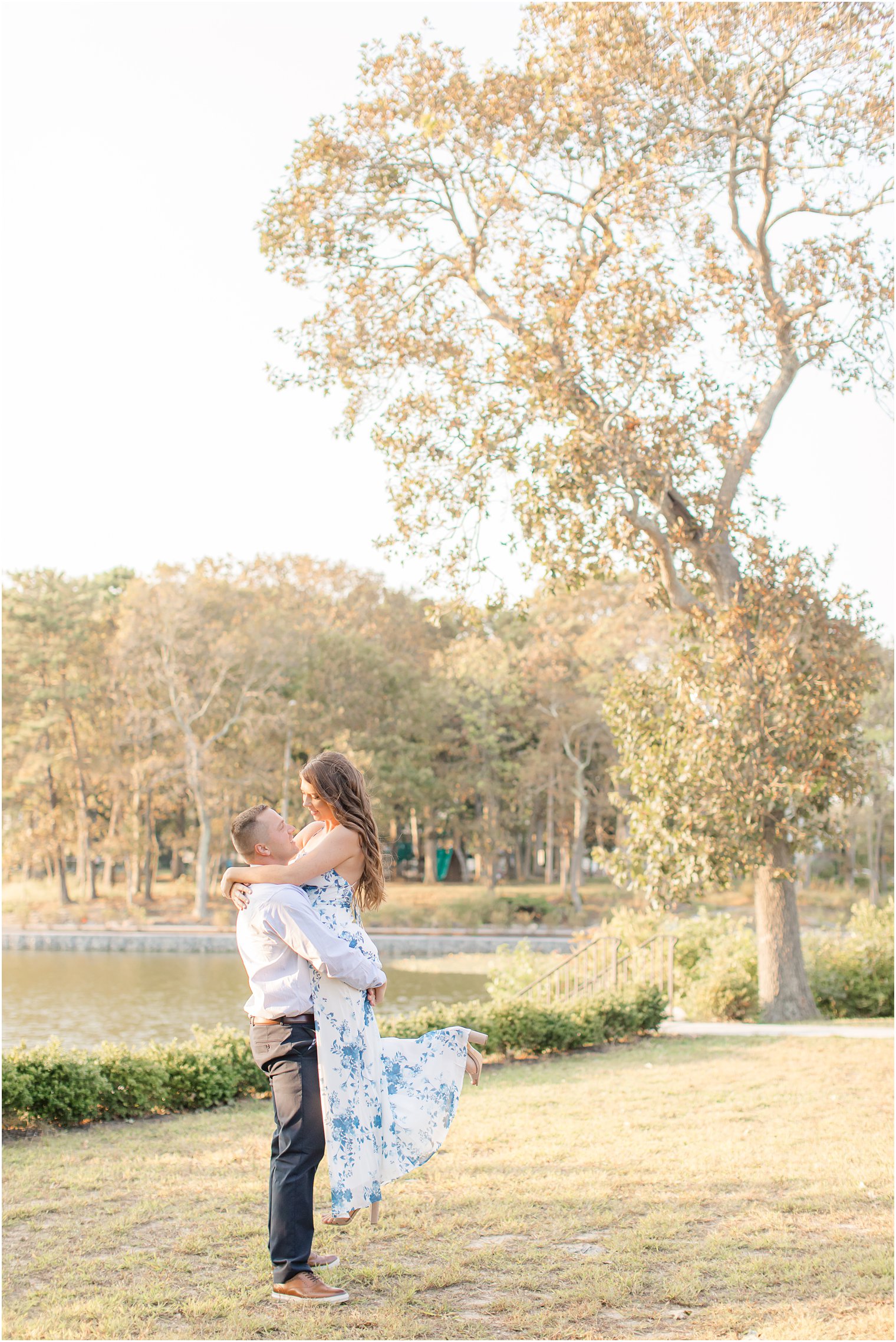 groom lifts bride during Spring Lake Engagement session