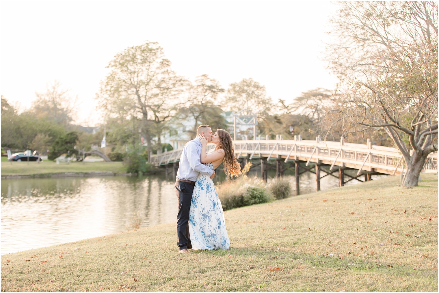 bride and groom kiss with local bridge in background