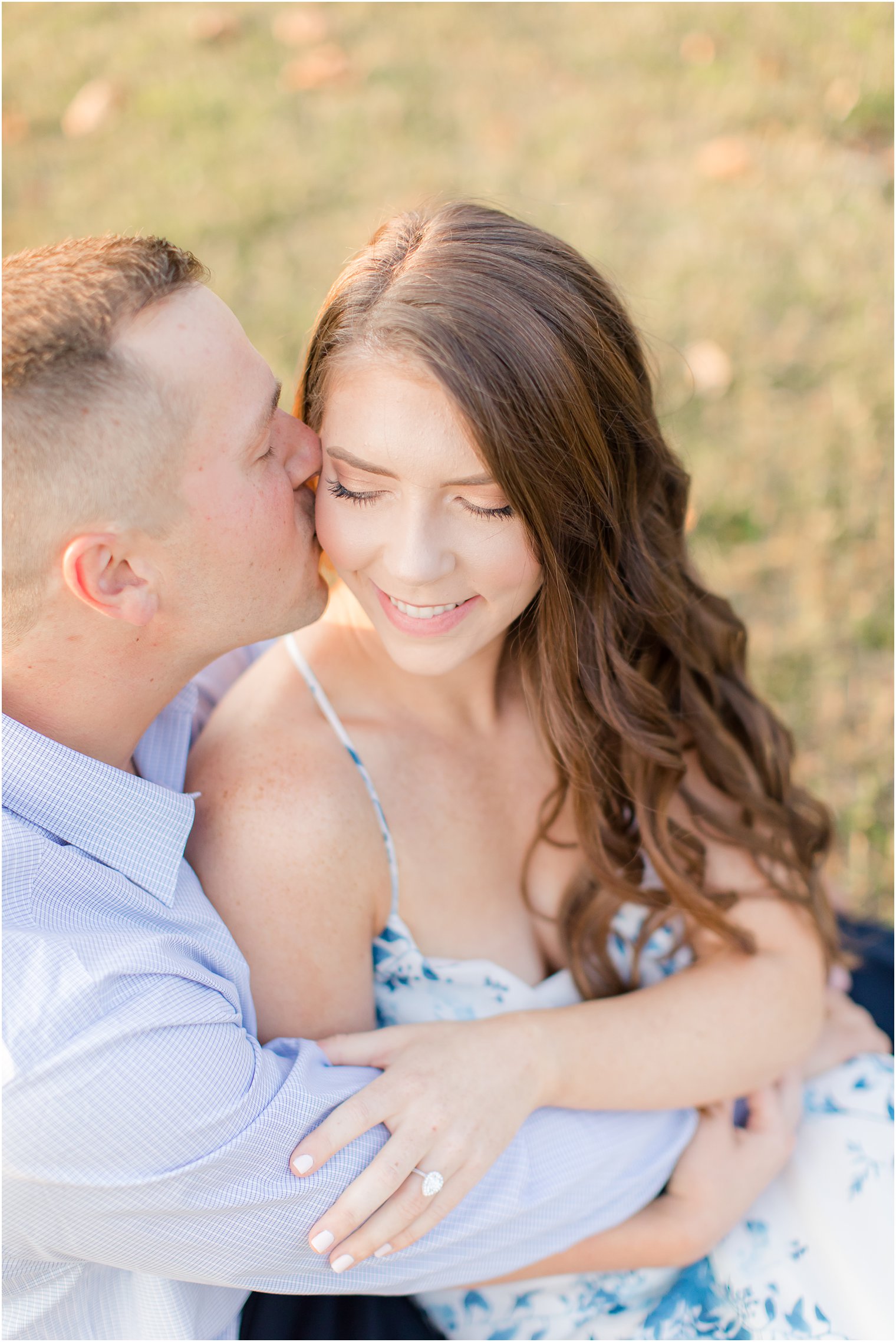 groom kisses bride-to-be during NJ engagement session in the fall