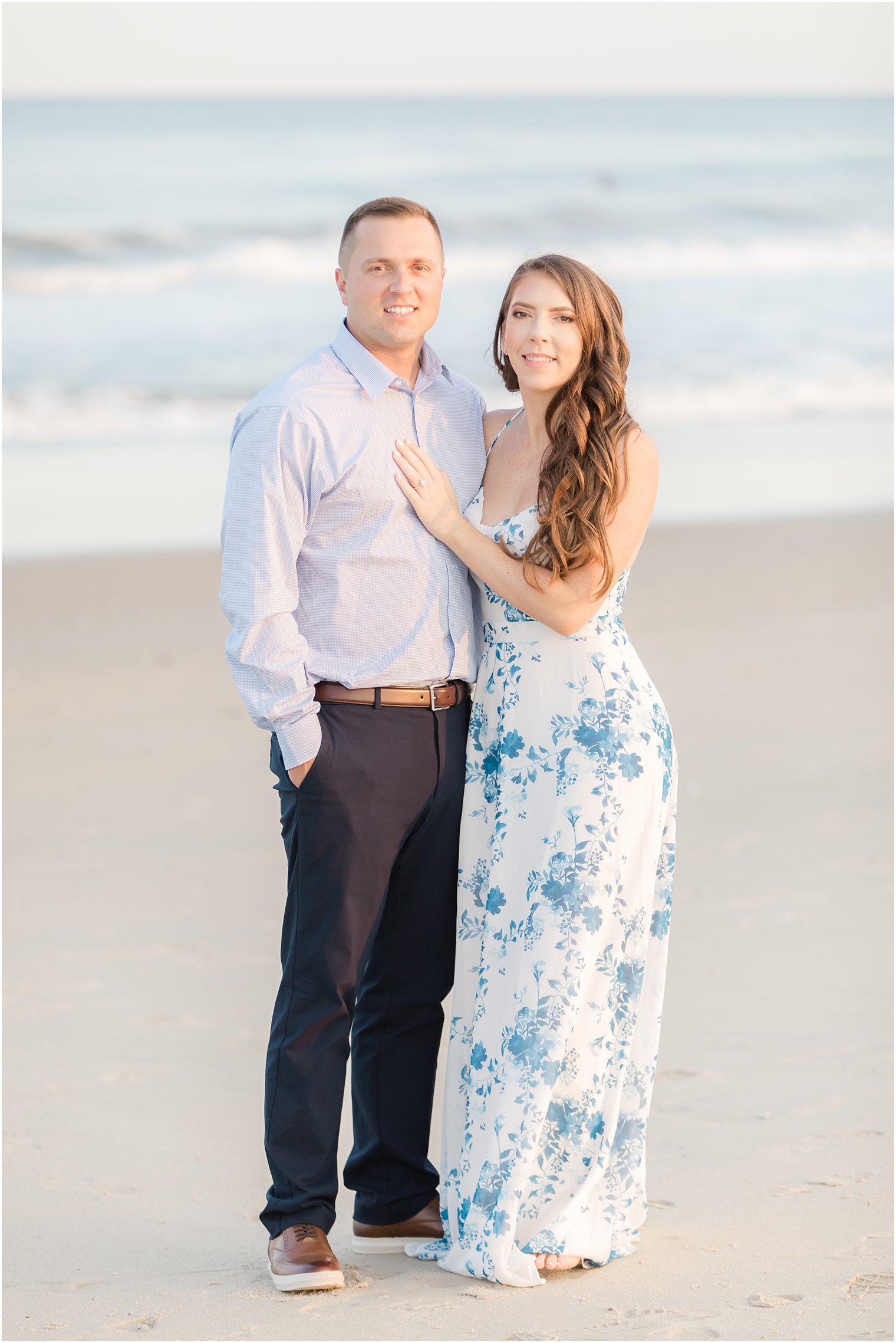 engaged couple poses on Spring Lake Beach in New Jersey