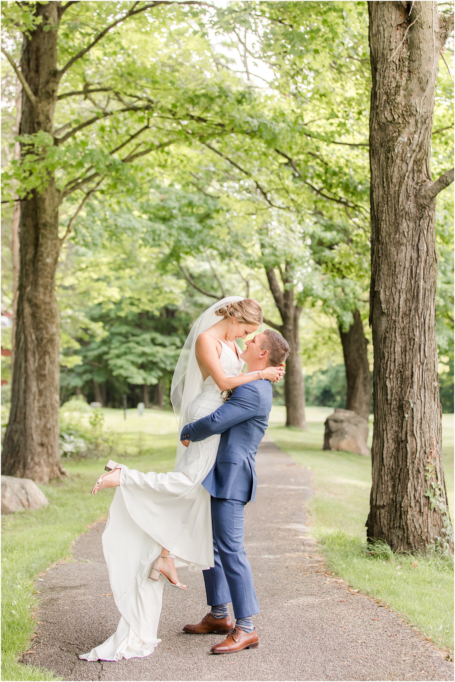 groom lifts up bride on trail at Minerals Resort