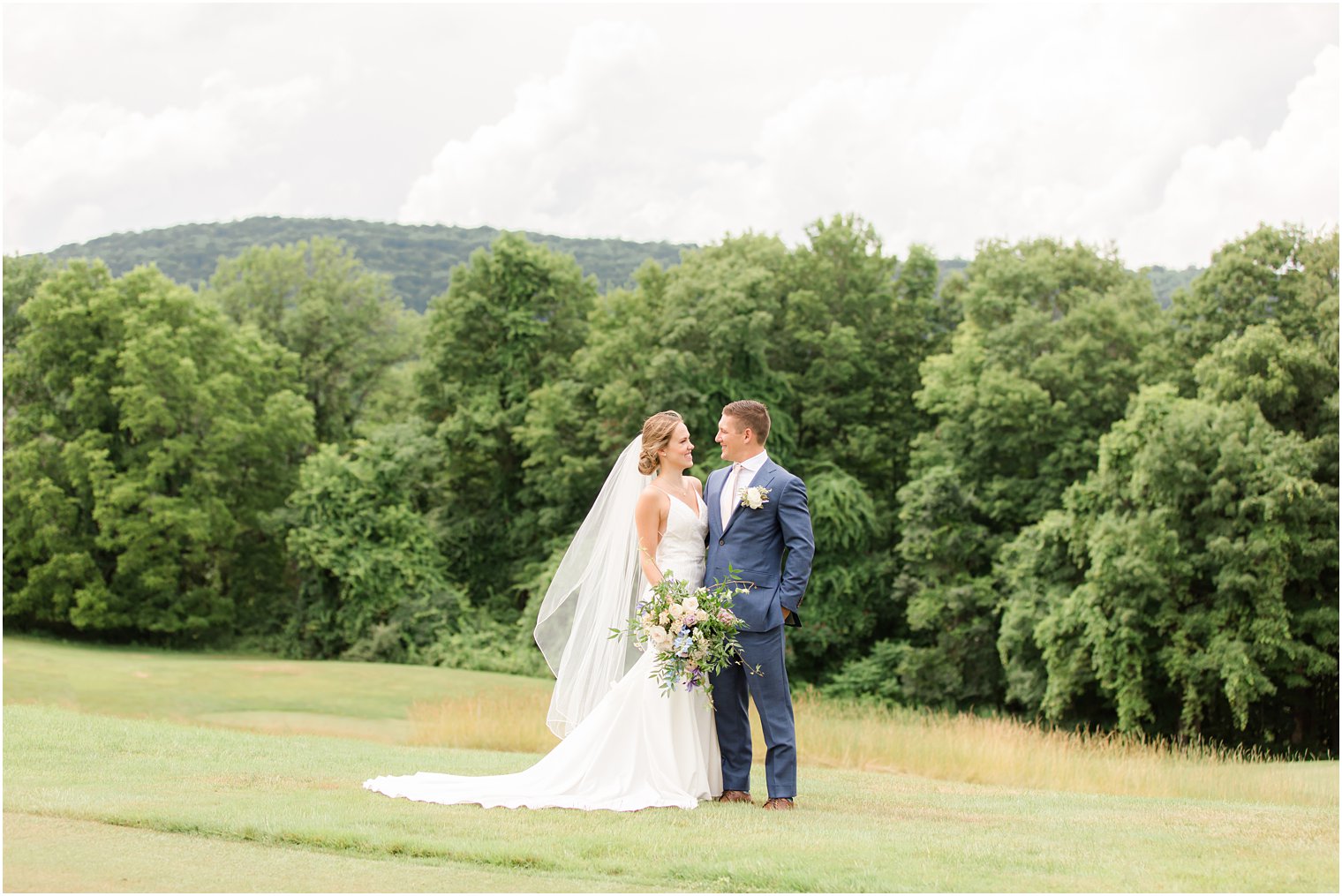 bride and groom hug side by side on field at Minerals Resort