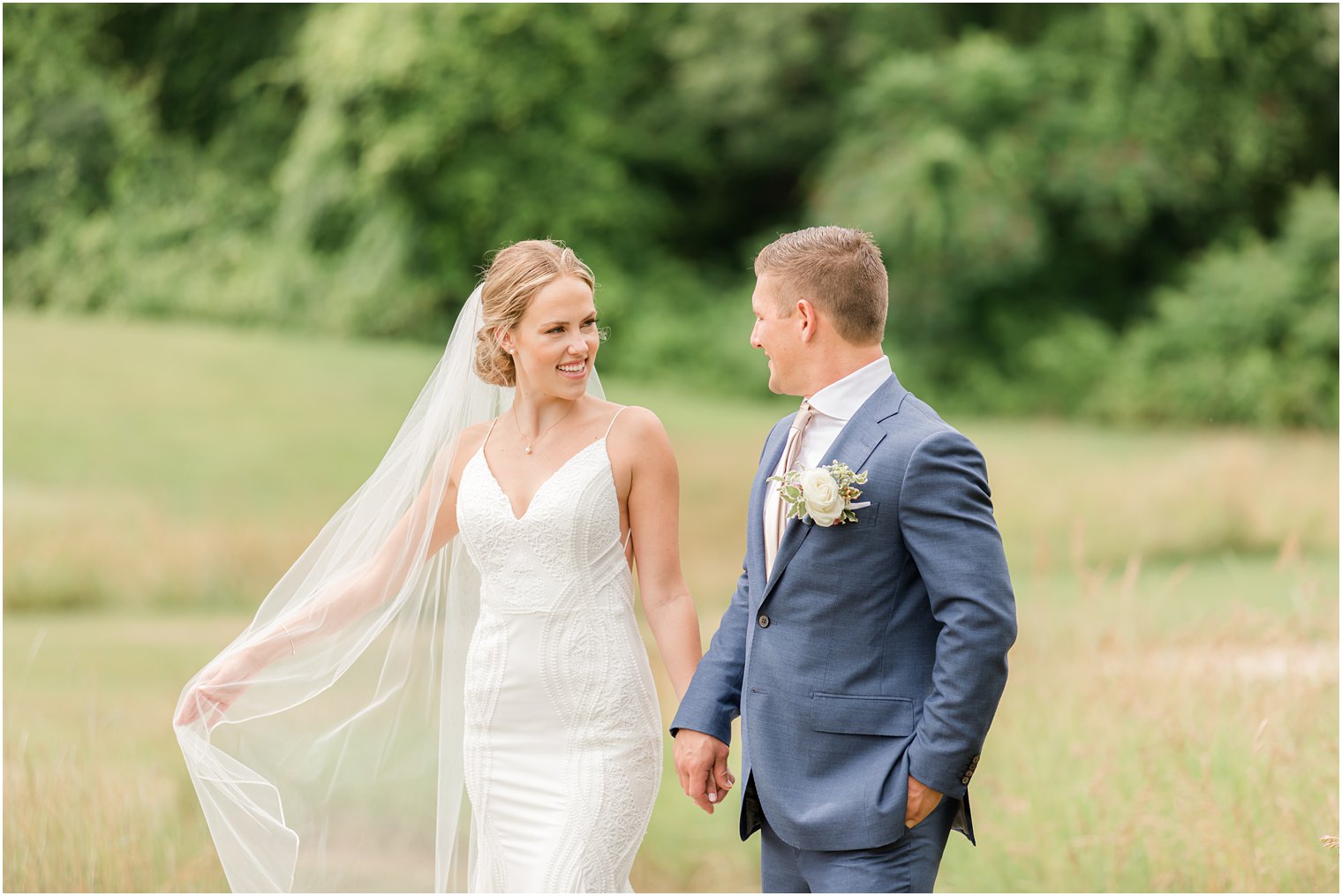 bride and groom hold hands walking through field at Minerals Resort