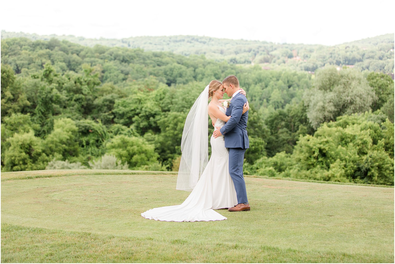 newlyweds hug on green at Minerals Resort