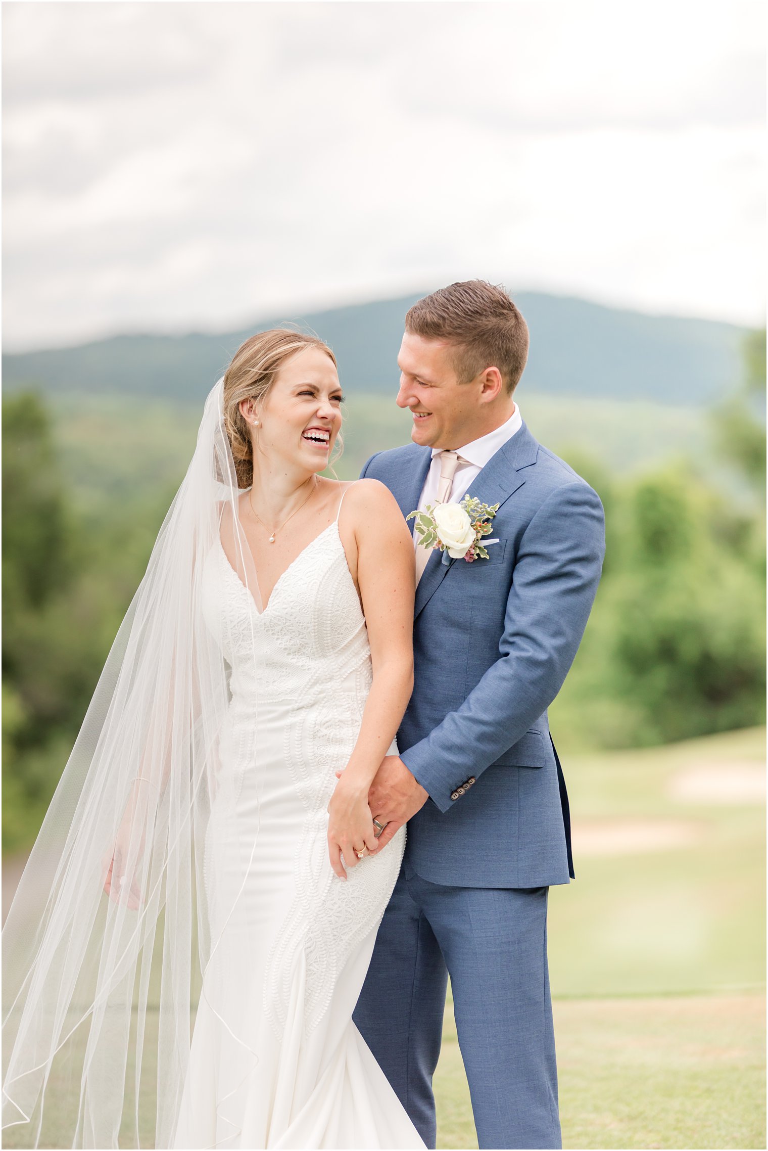 bride and groom hold hands smiling at each other in Vernon NJ