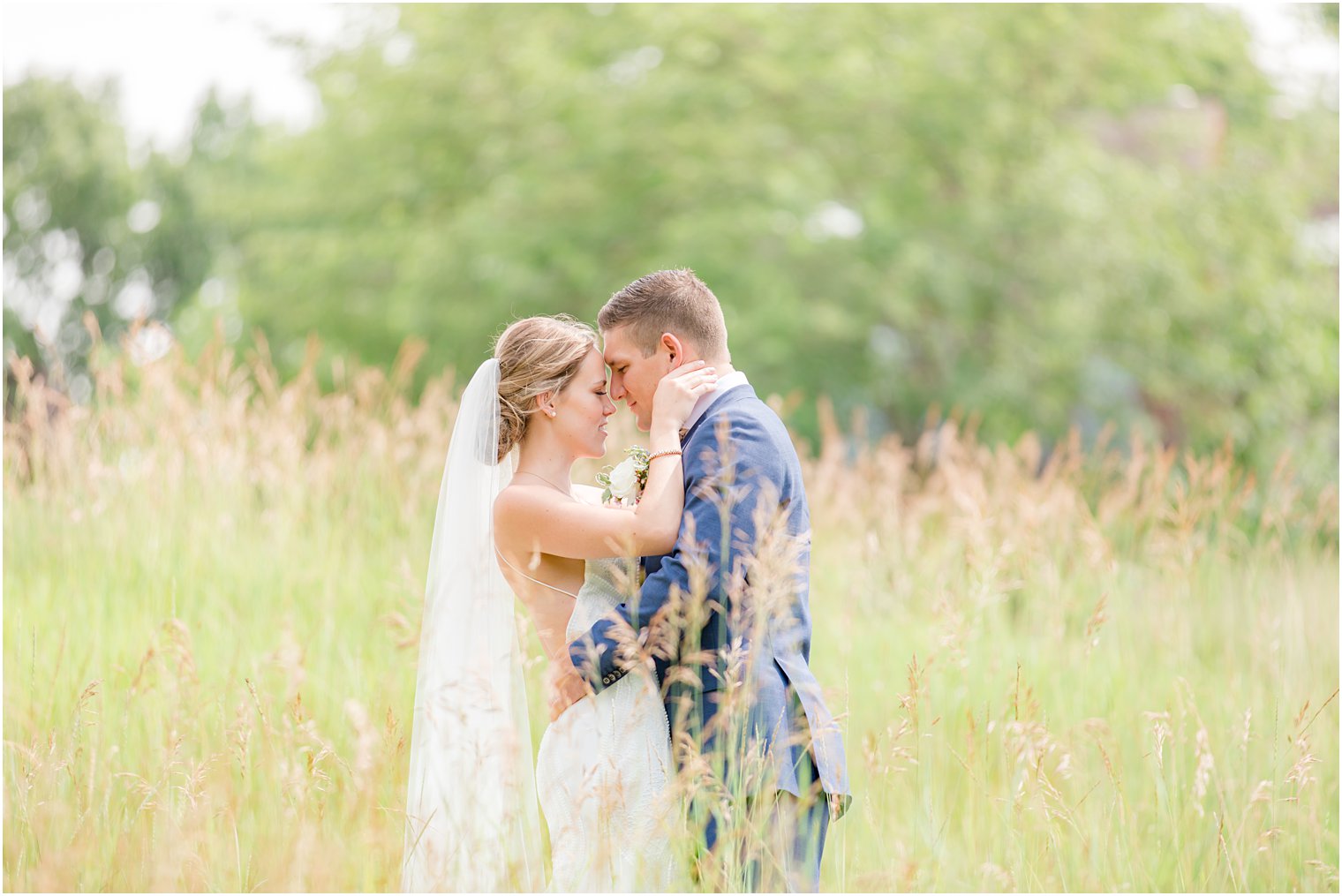 newlyweds stand nose to nose in field at Minerals Resort