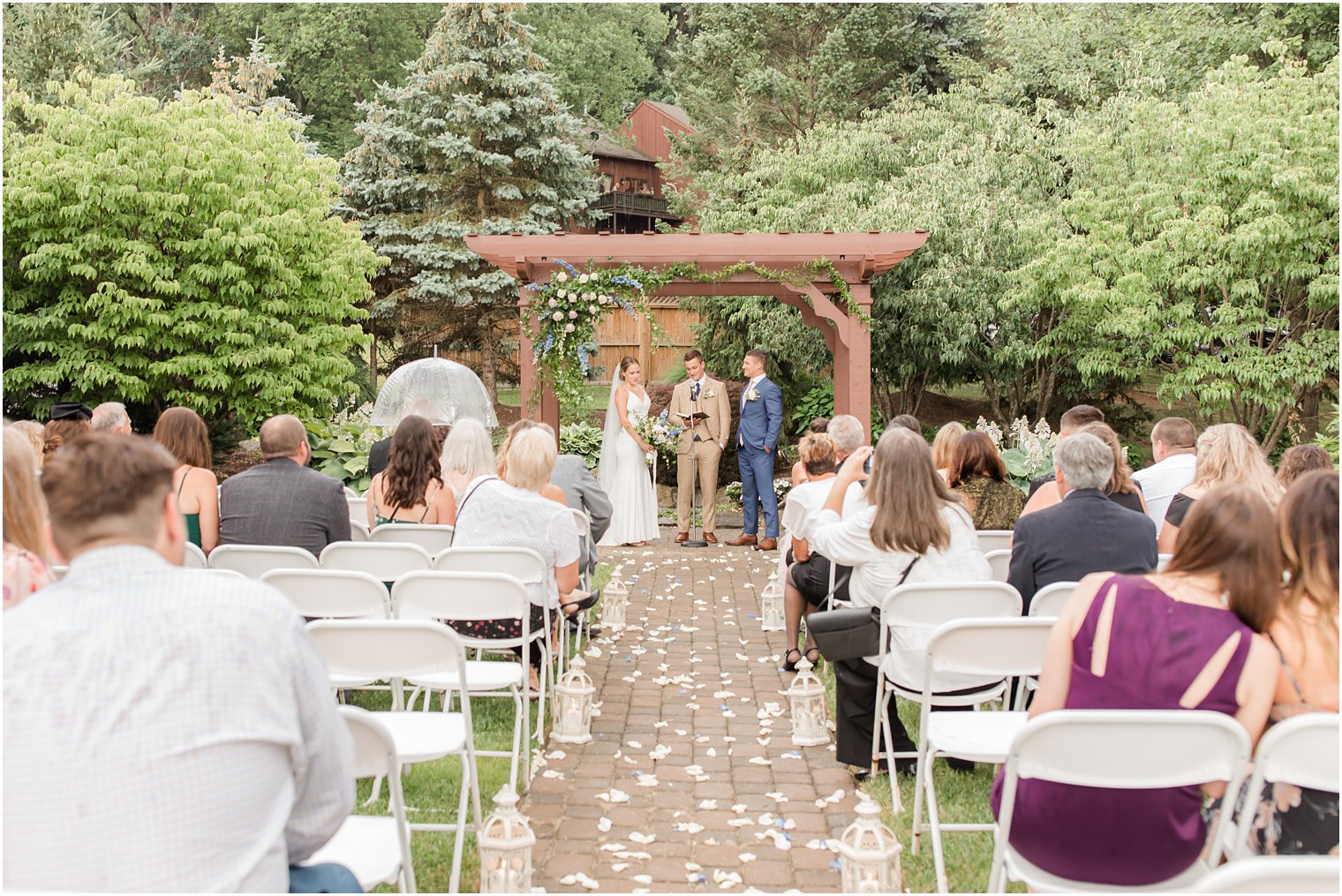 bride and groom listen to officiant during rainy wedding ceremony in Vernon NJ