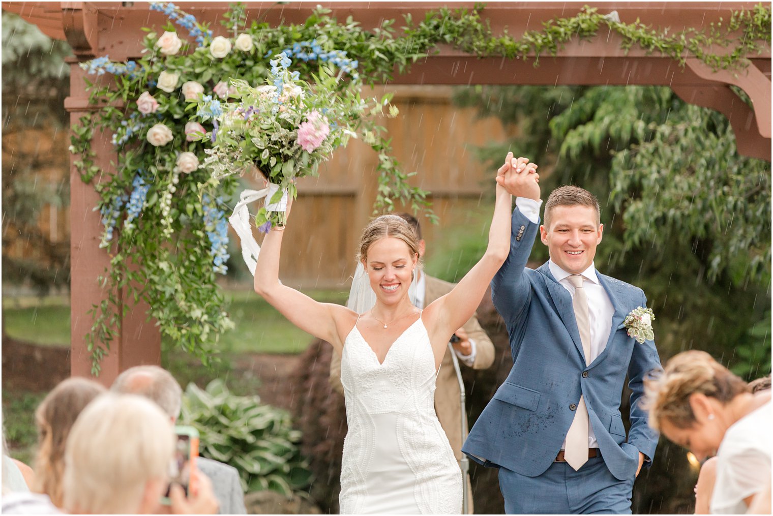 newlyweds cheer walking in the rain after wedding ceremony at Minerals Resort