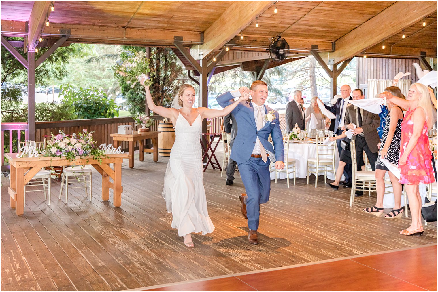 bride and groom cheer walking into wedding reception at Minerals Resort