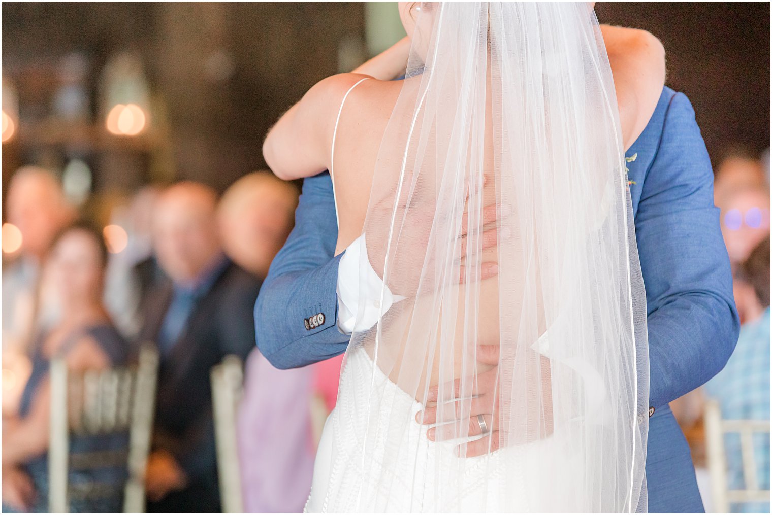 groom hugs bride during first dance in New Jersey 