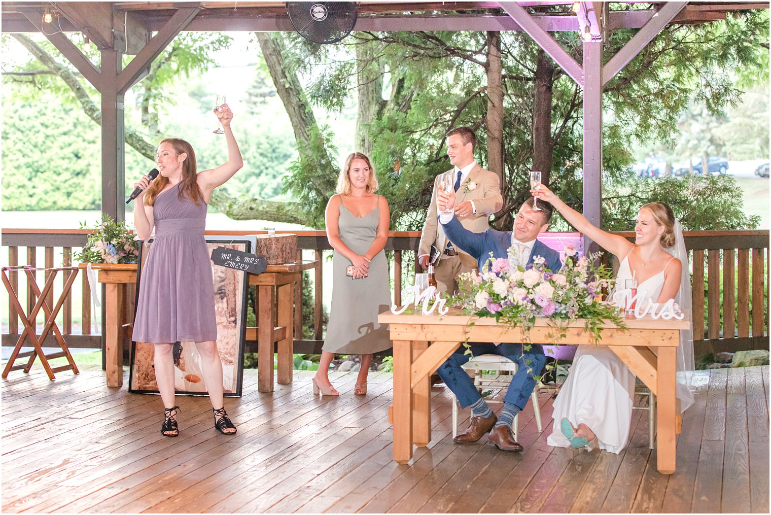 bride and groom sit at sweetheart table during toasts at NJ wedding reception