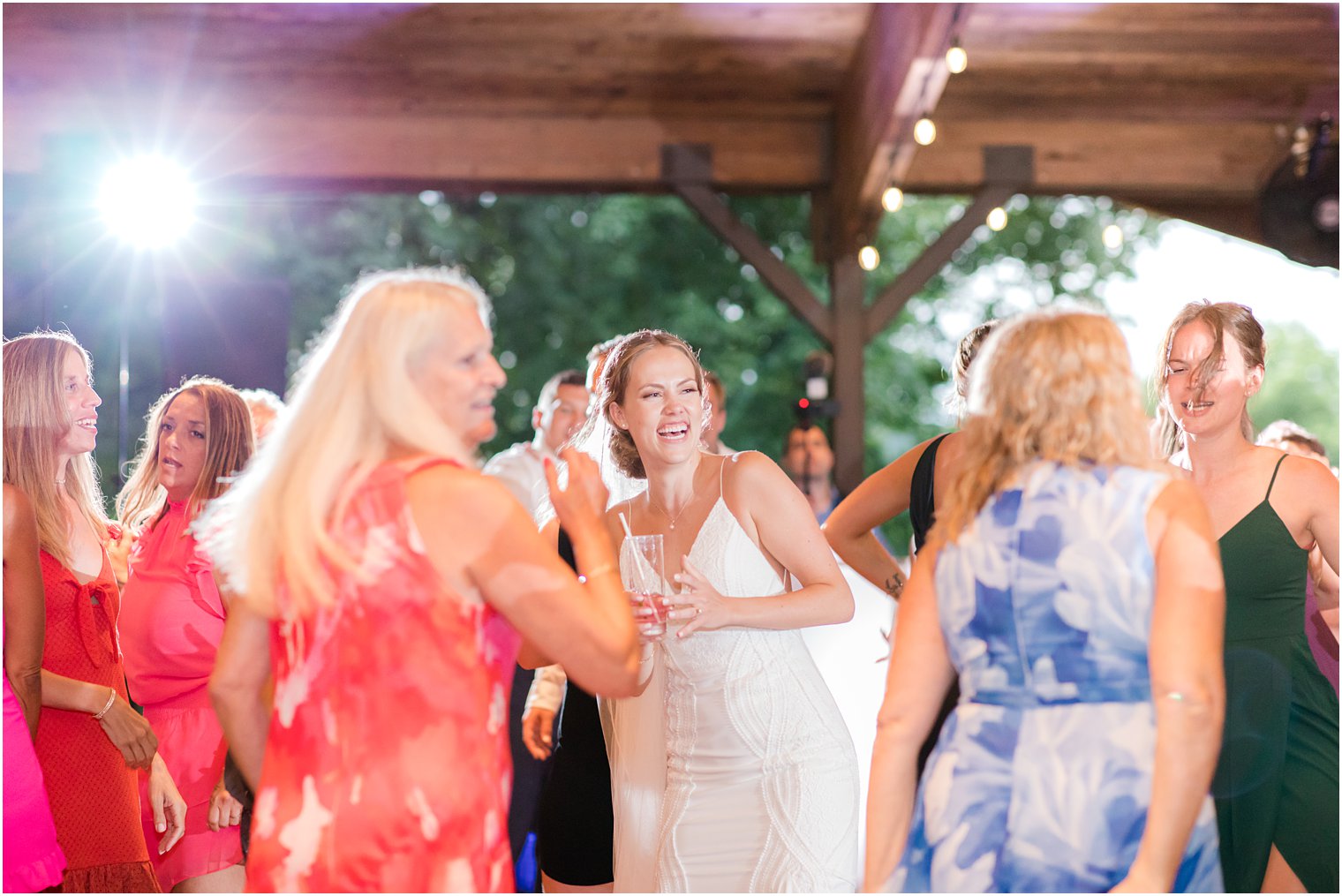 bride laughs dancing with guests New Jersey wedding reception