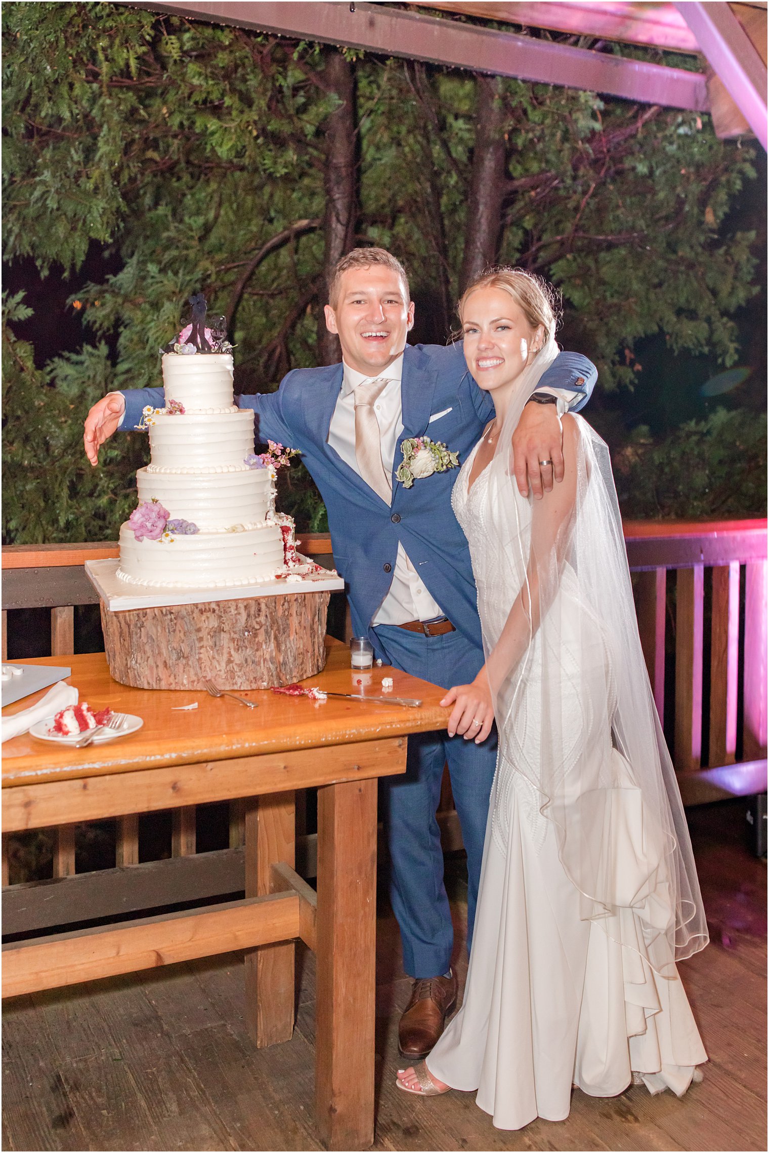 newlyweds ug by wedding cake at Minerals Resort