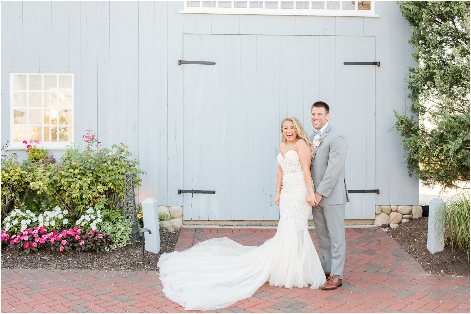 bride and groom holds hands by blue wooden door at Bonnet Island Estate
