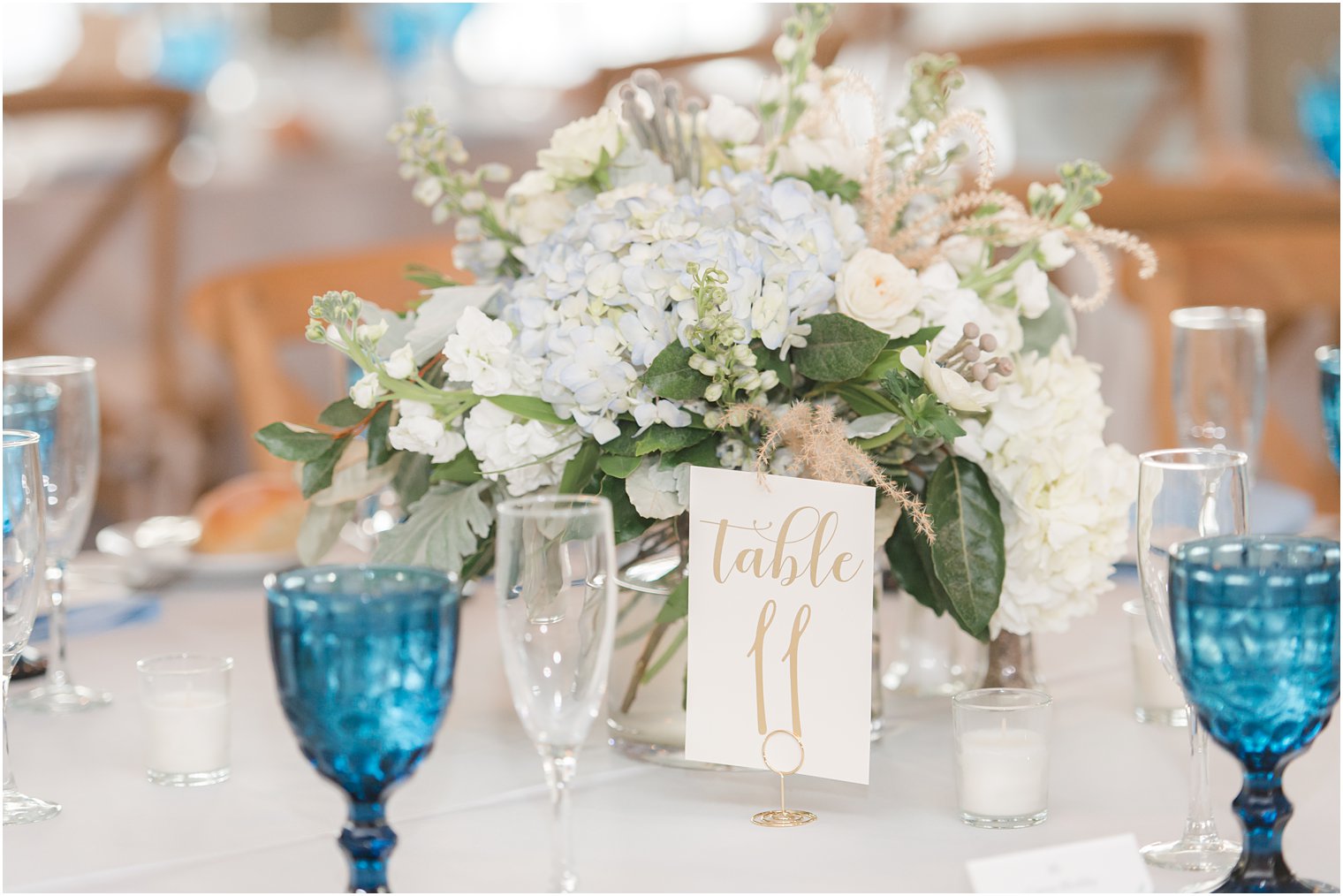 light blue floral centerpieces with vintage glasses at Brant Beach Yacht Club wedding reception 