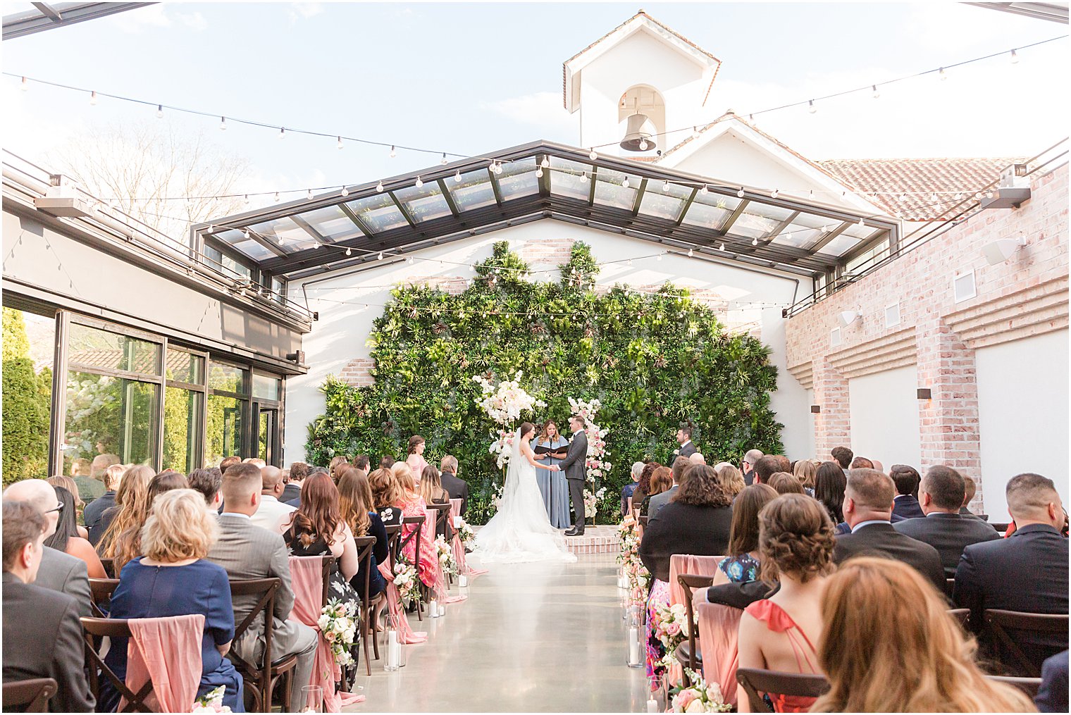 couple exchanges vows during outdoor wedding ceremony in courtyard