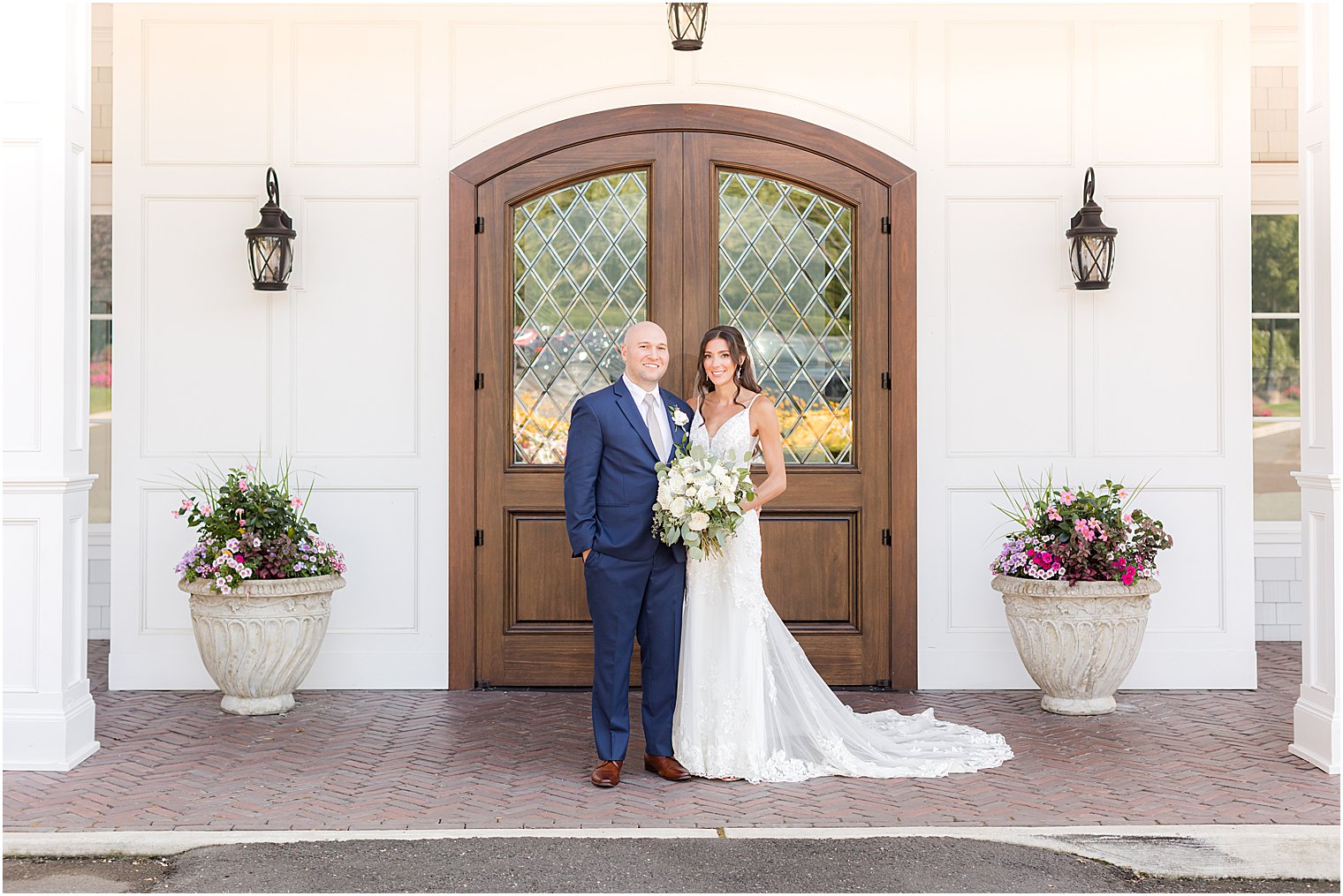 bride and groom stand by wooden door outside The Mill Lakeside Manor