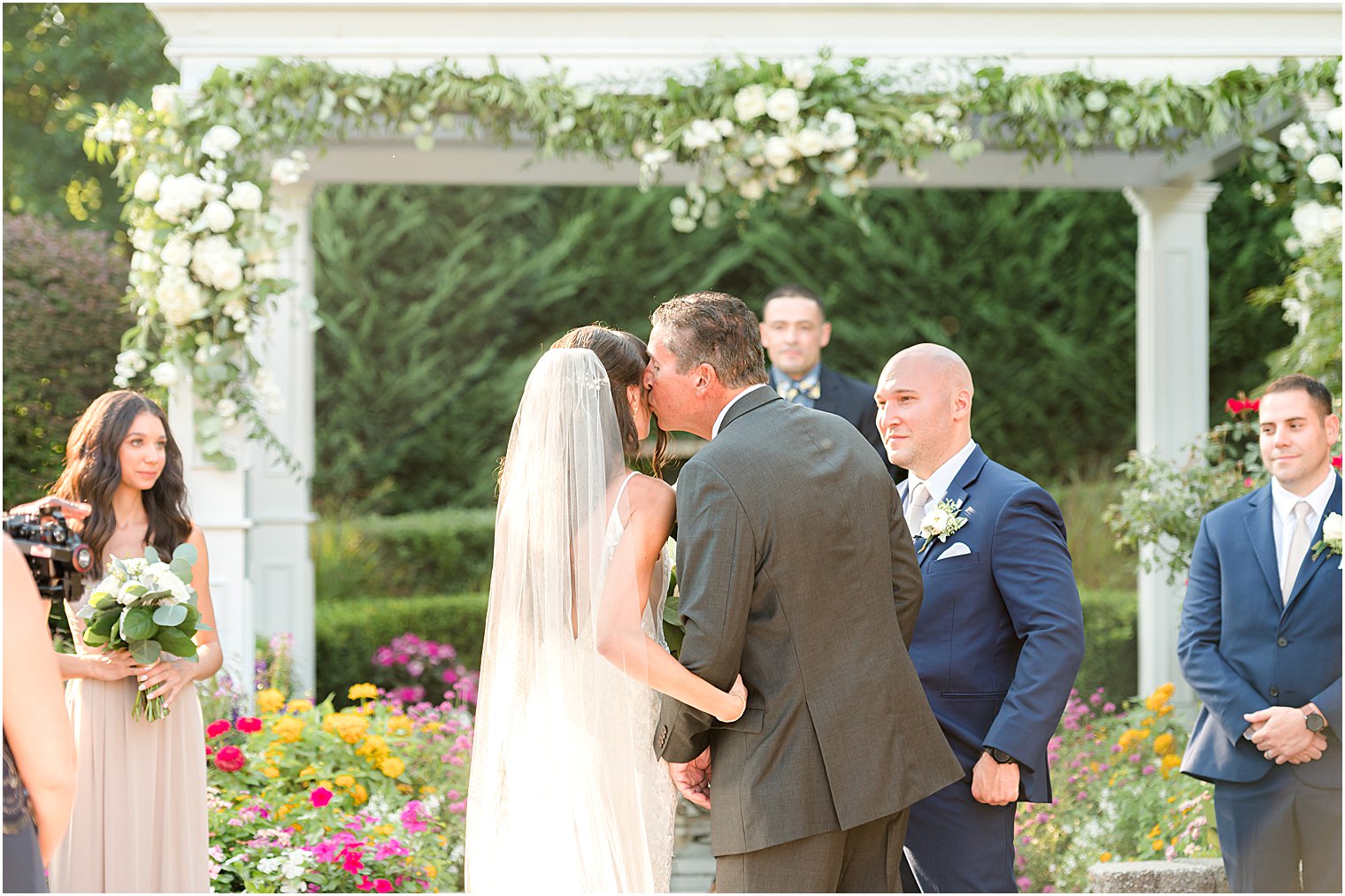 father kisses bride's cheek during NJ wedding ceremony