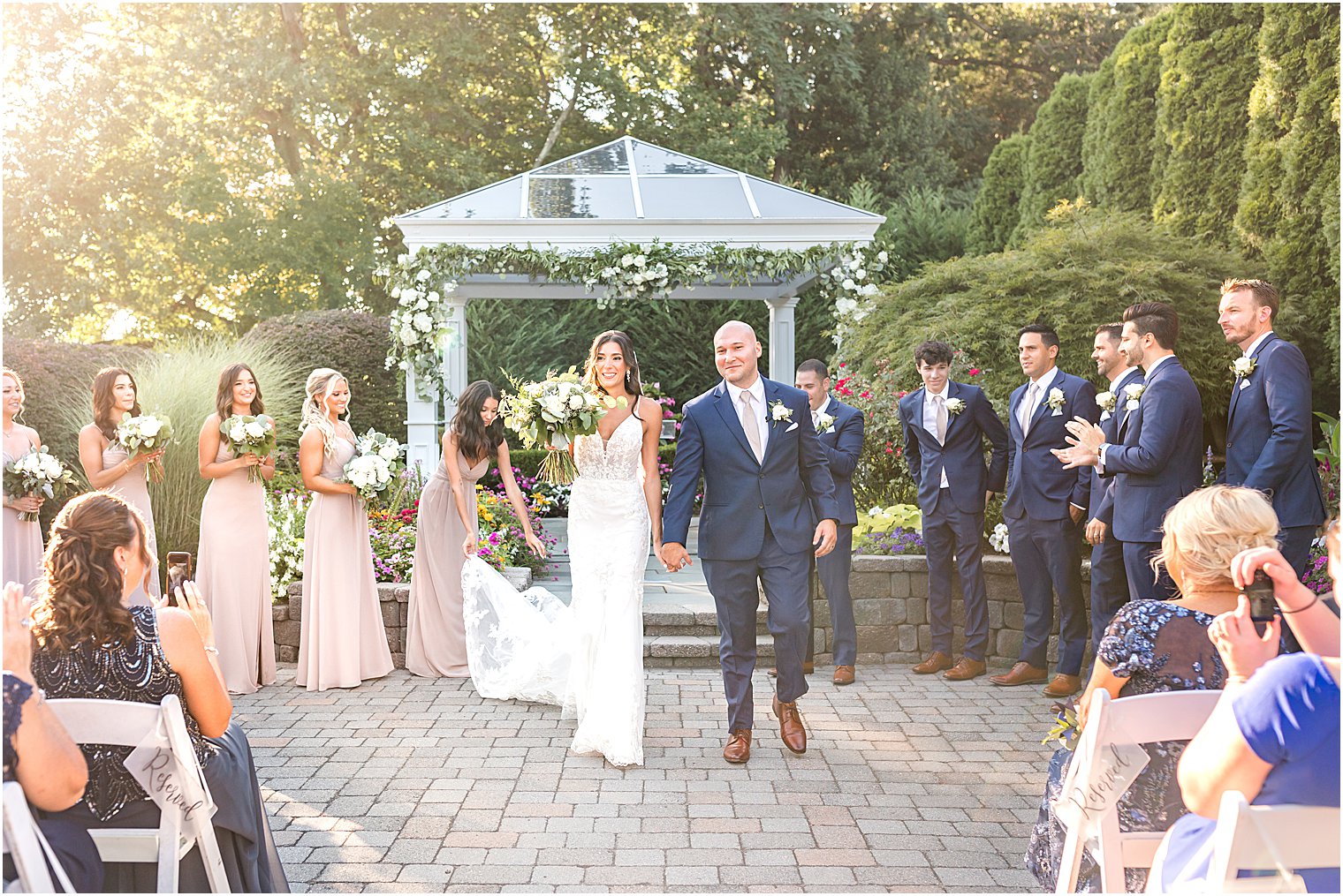 bride and groom walk up aisle after garden wedding ceremony in New Jersey