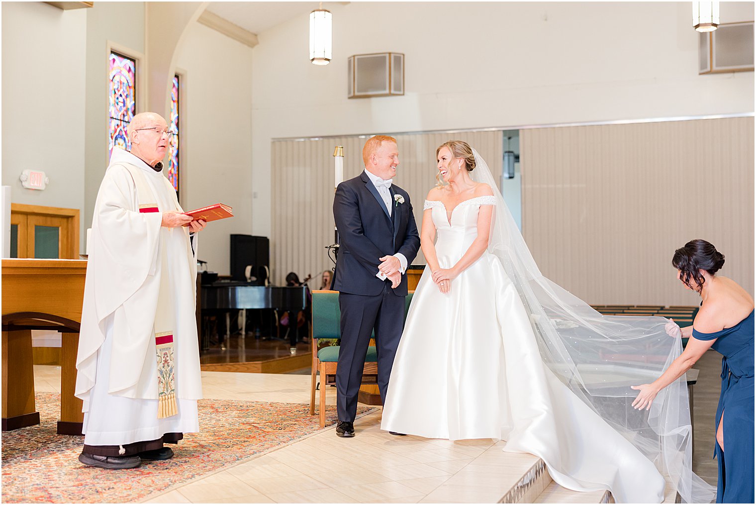 bride and groom smile together at each other during traditional church wedding on Long Beach Island