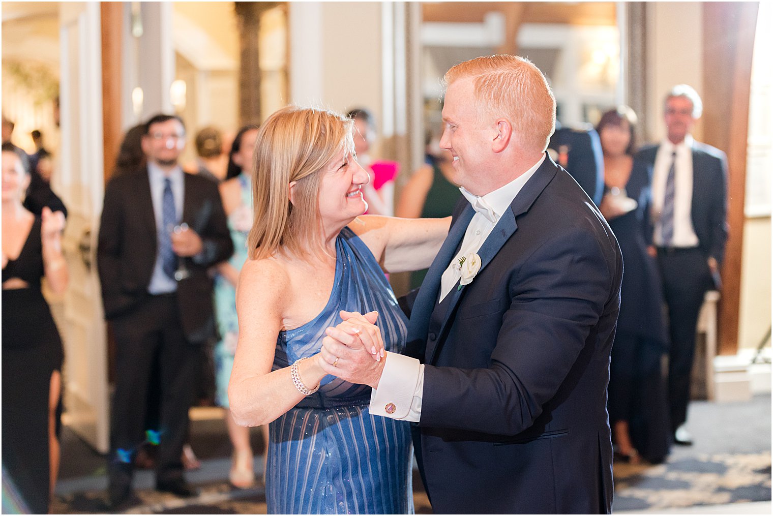 groom dances with mother in blue dress during LBI wedding reception