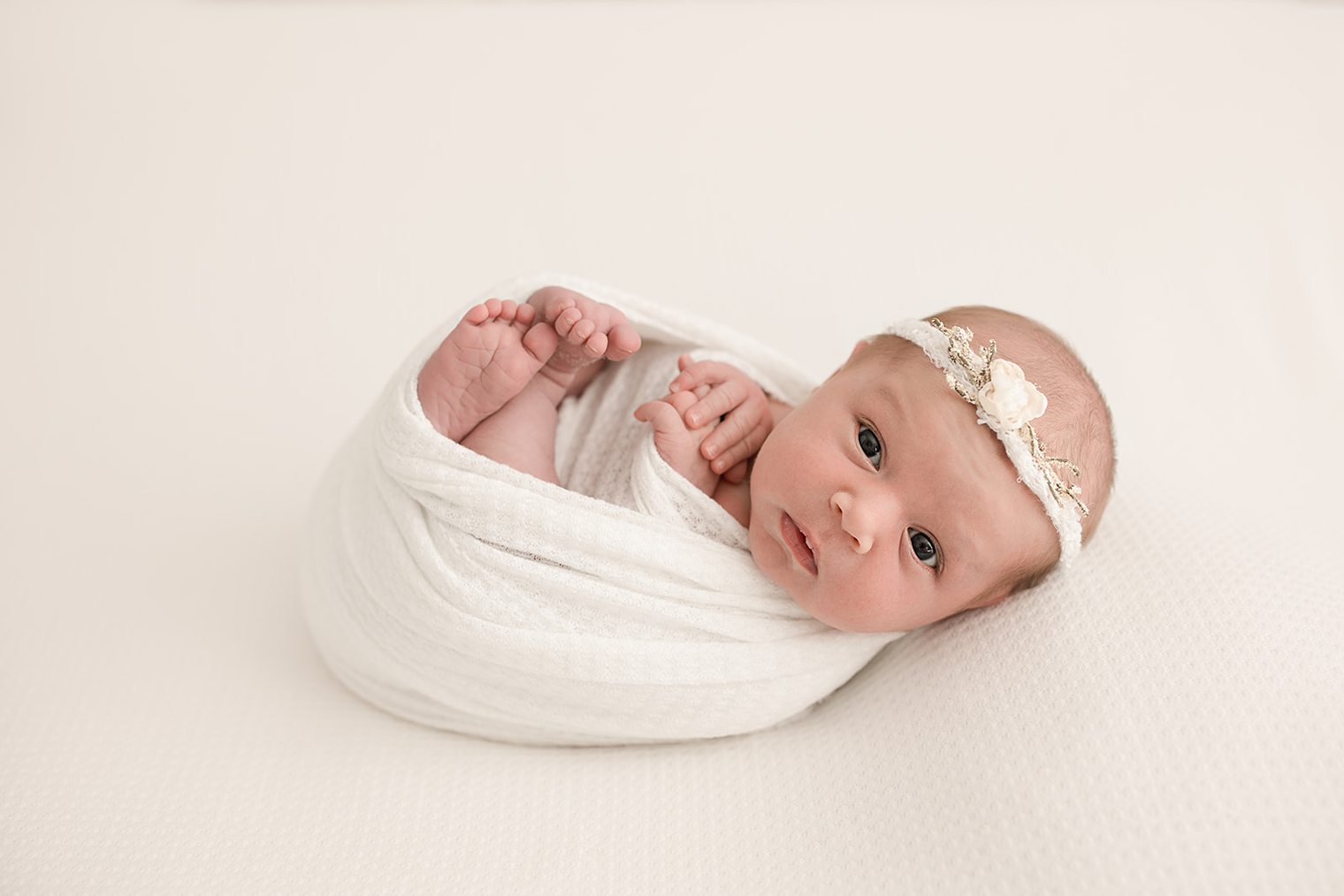 curious baby girl in her new born session 