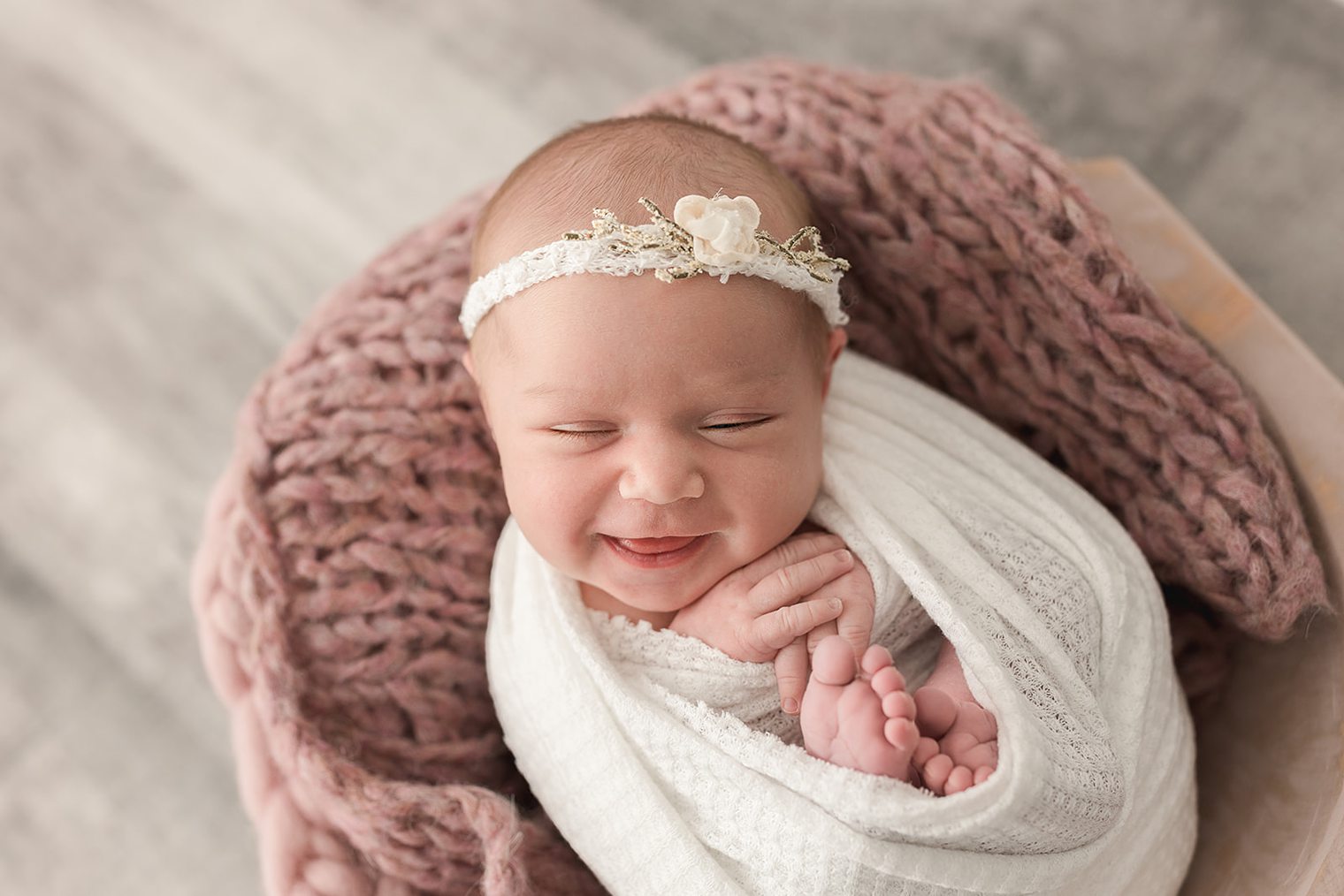 smiling new born baby girl in her new born session 