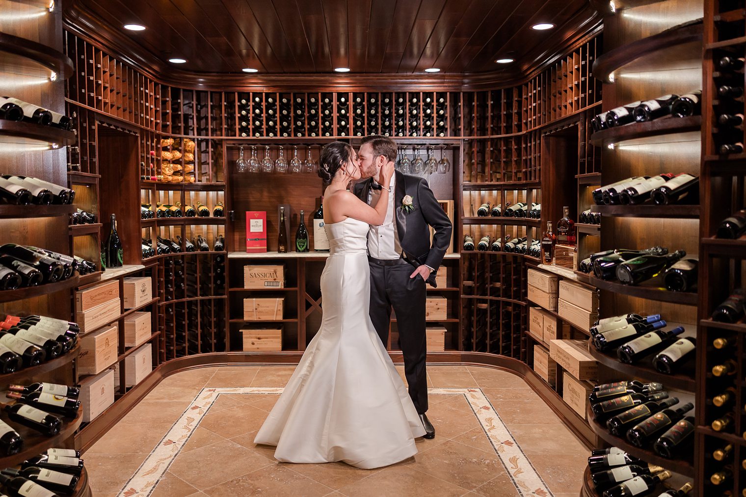 husband and wife sharing a kiss n the wine cellar