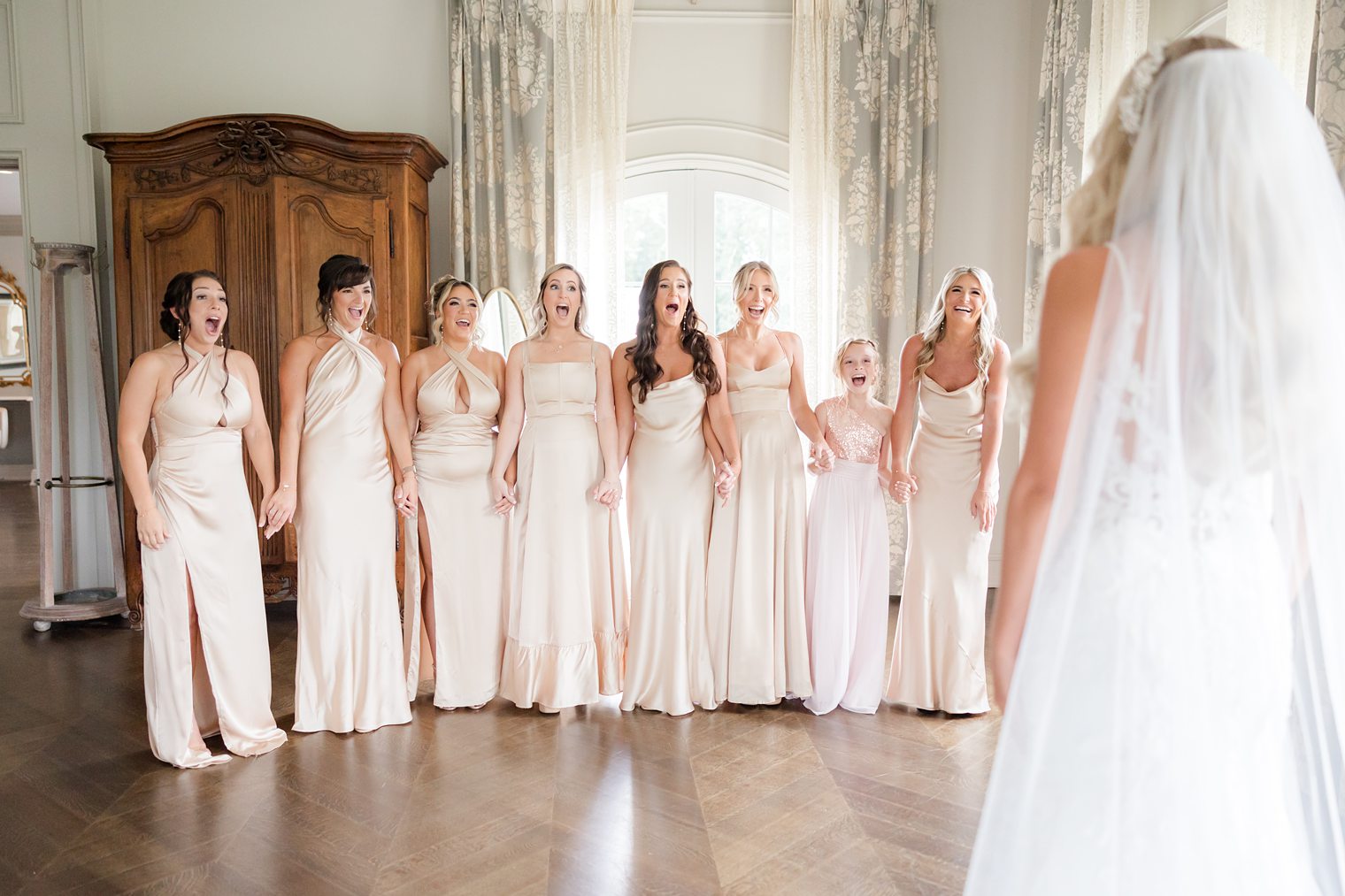 bride ready to say I do, showing to her bridesmaids 