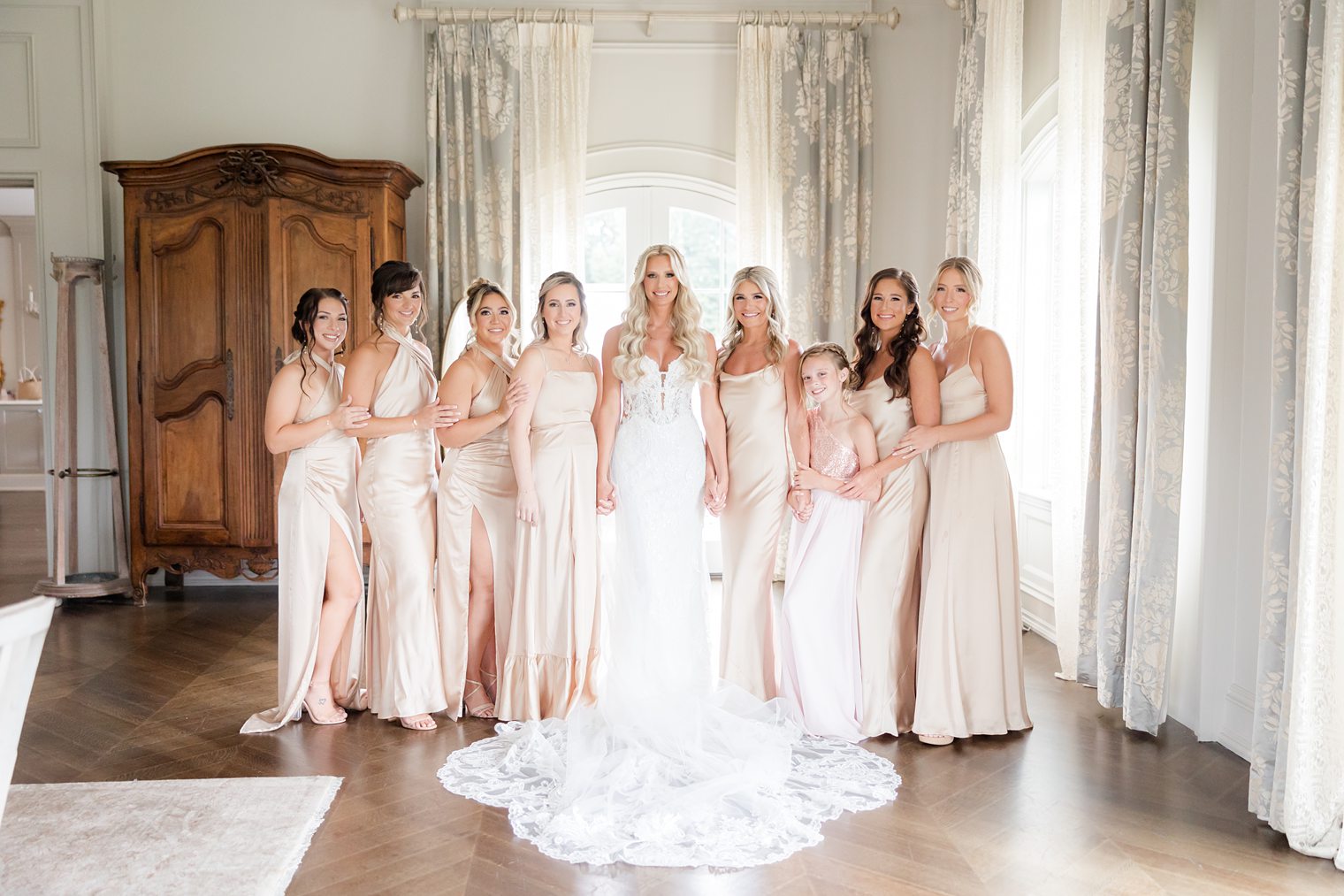 bride with her bridesmaids posing for her wedding session