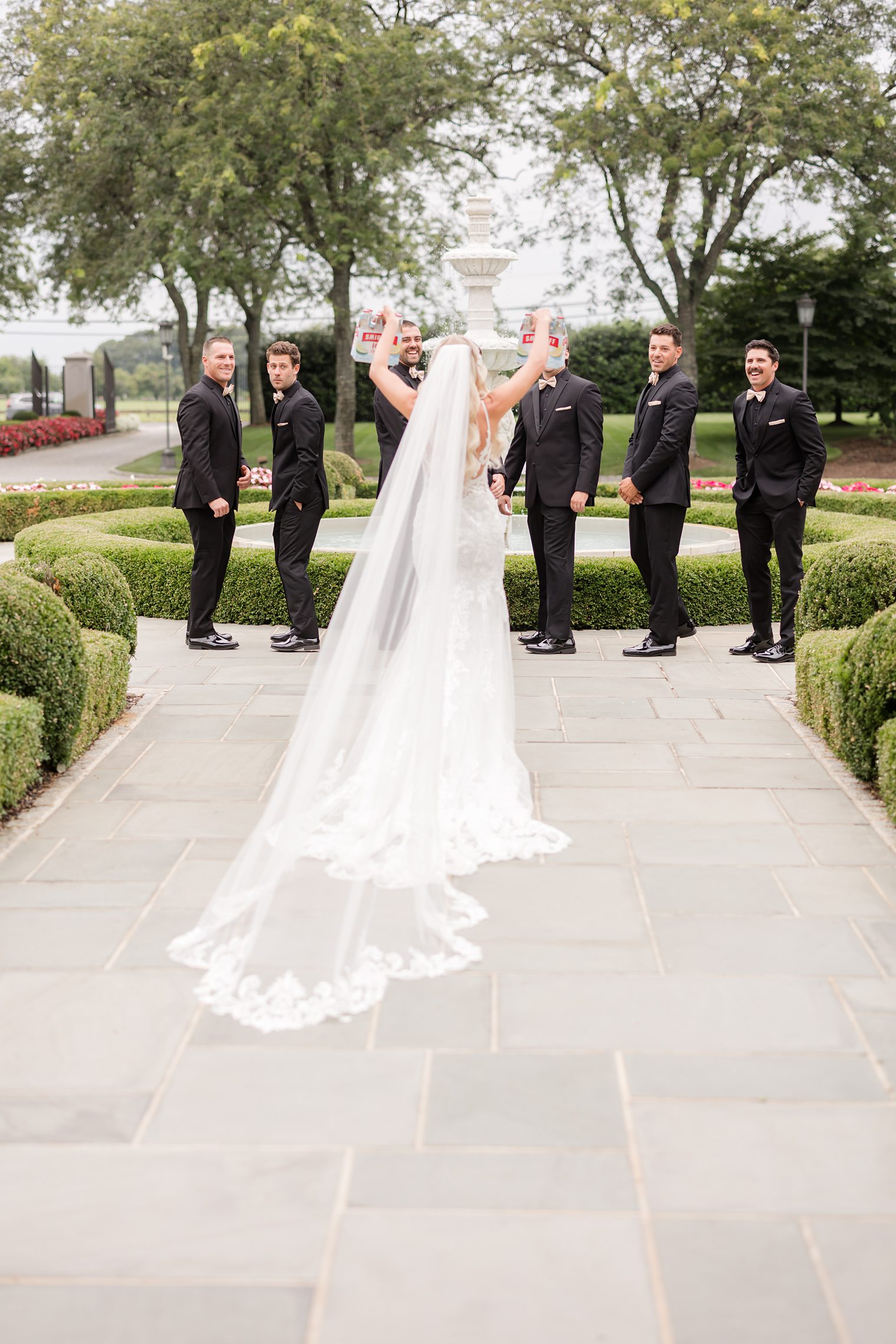 bride bringing drinks to the best men of her future husband 