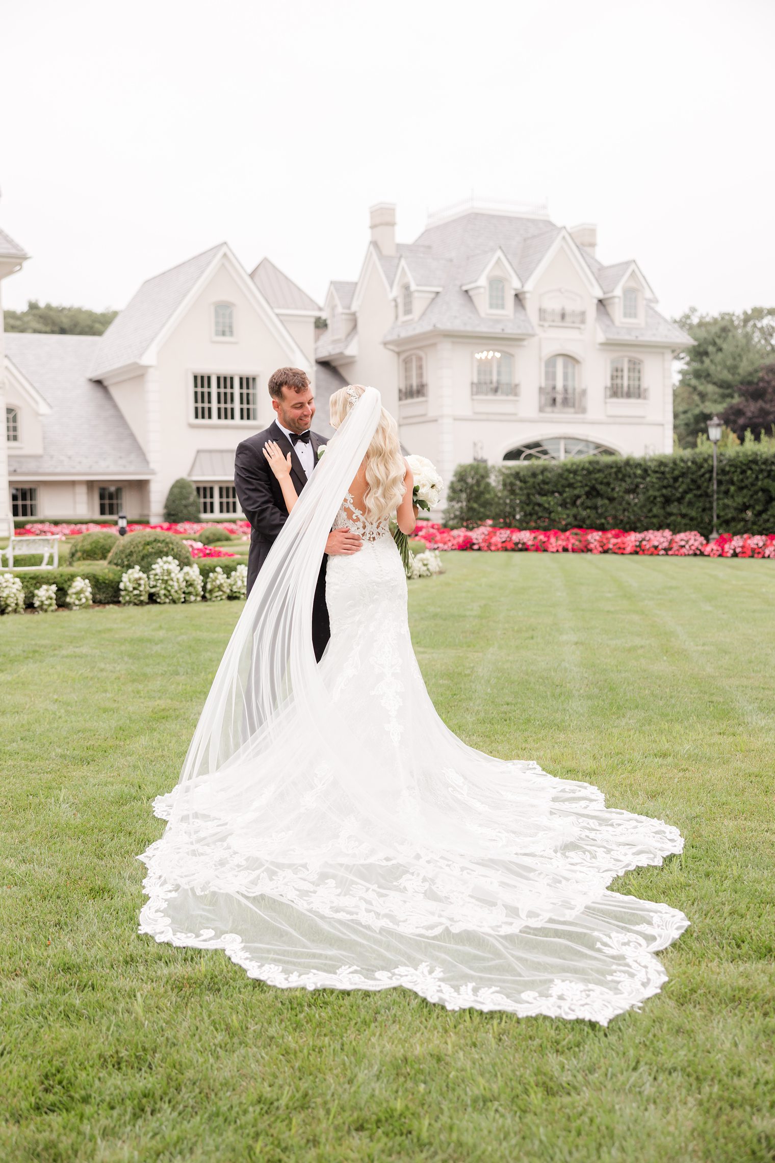 bride showing her dress while she looks to her groom