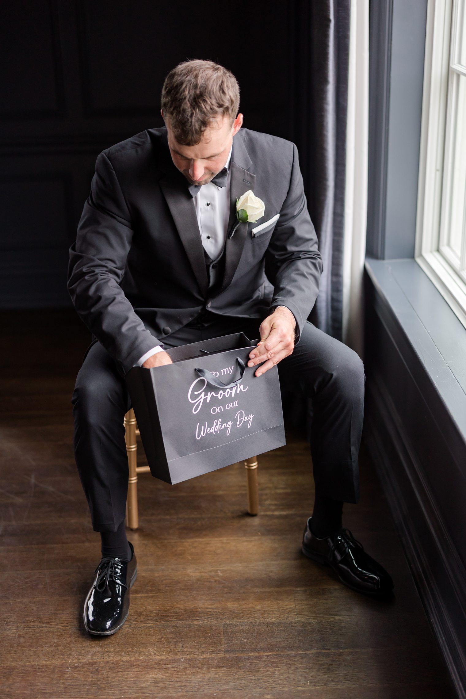 groom opening a wedding gift 