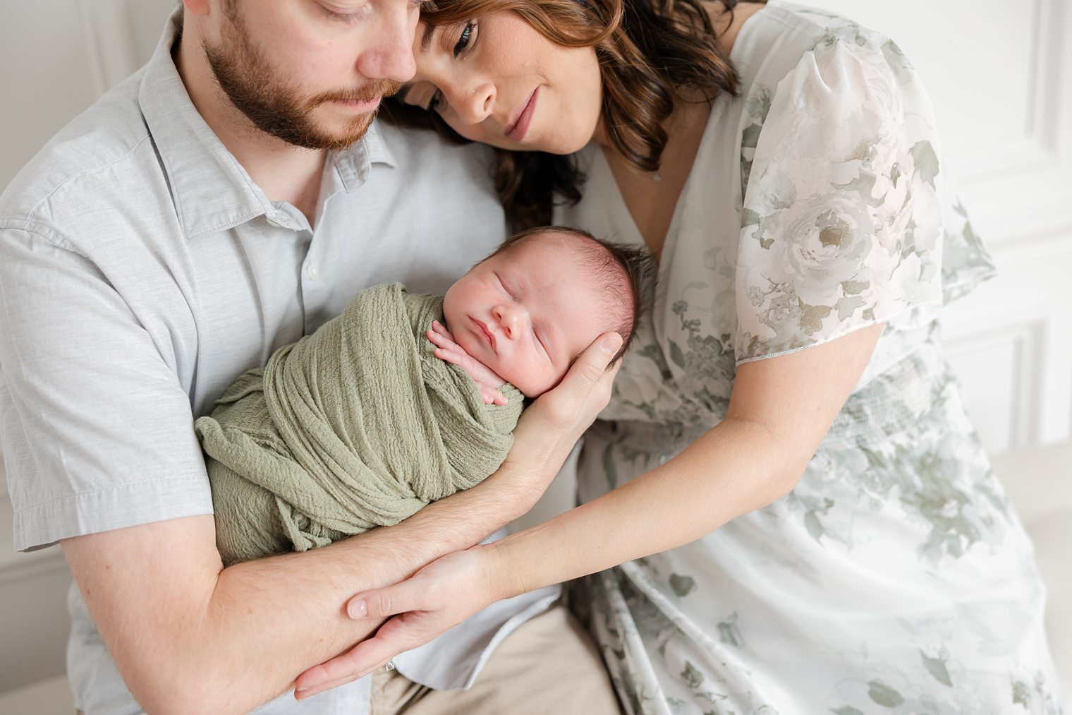 mom and dad looking with love to their baby boy